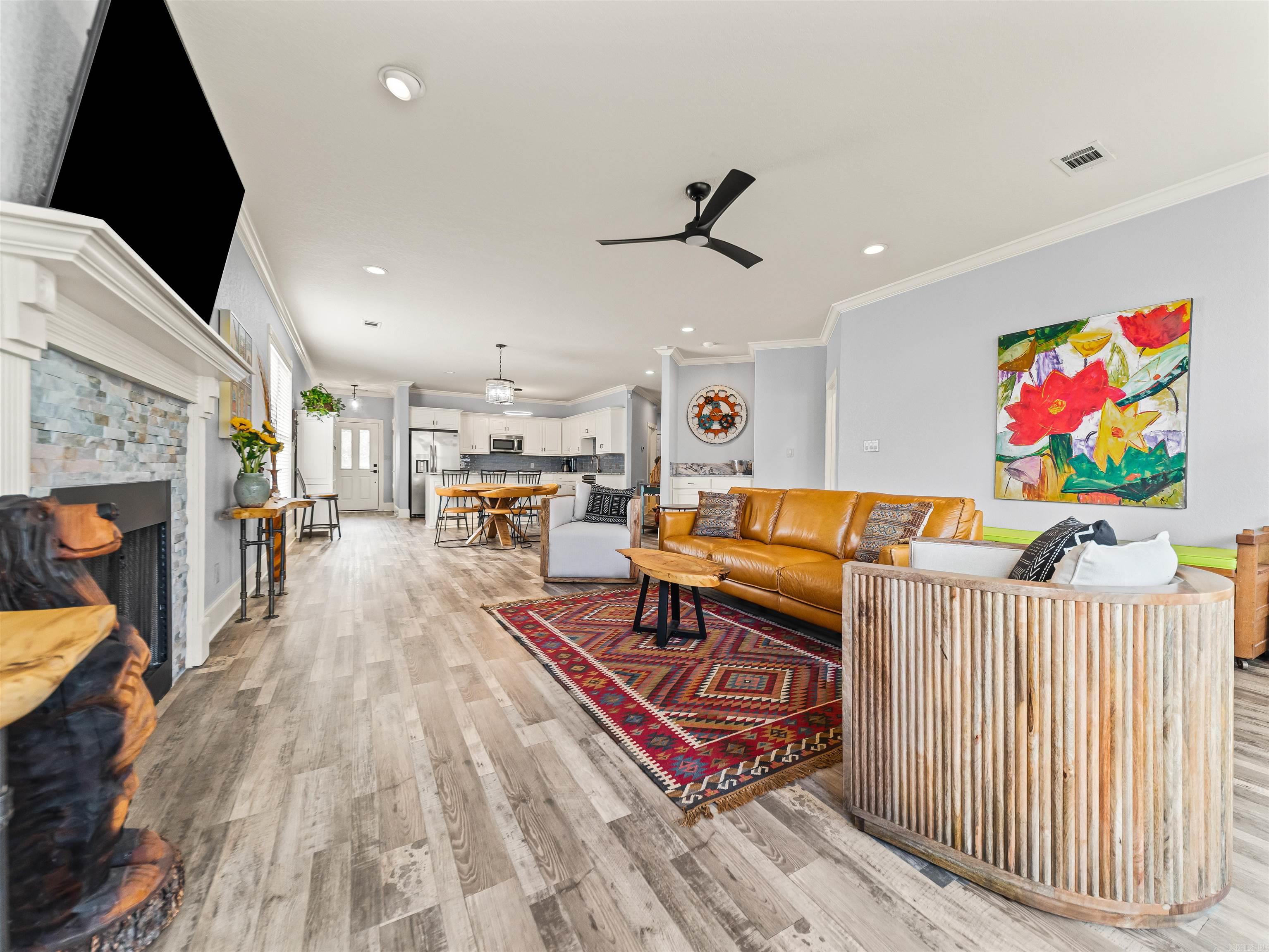 Tucked away in the centrally-located gated community of Lighthouse Cove, this well-maintained home pairs a functional layout with effortless, HOA-provided lawn care. The main level centers around an open-concept kitchen, dining, and living area perfect for hosting, with French doors leading from both the main living space and the large primary suite out to the deck. Upstairs, a massive second living room offers excellent flexibility as a media space or lounge, accompanied by two spacious bedrooms that each feature a private en suite bath and a walk-in closet. Complete with lake views from the upper deck, a neighborhood boardwalk, and a prime location just one mile from Central Avenue shopping and dining, this property delivers ultimate everyday convenience!