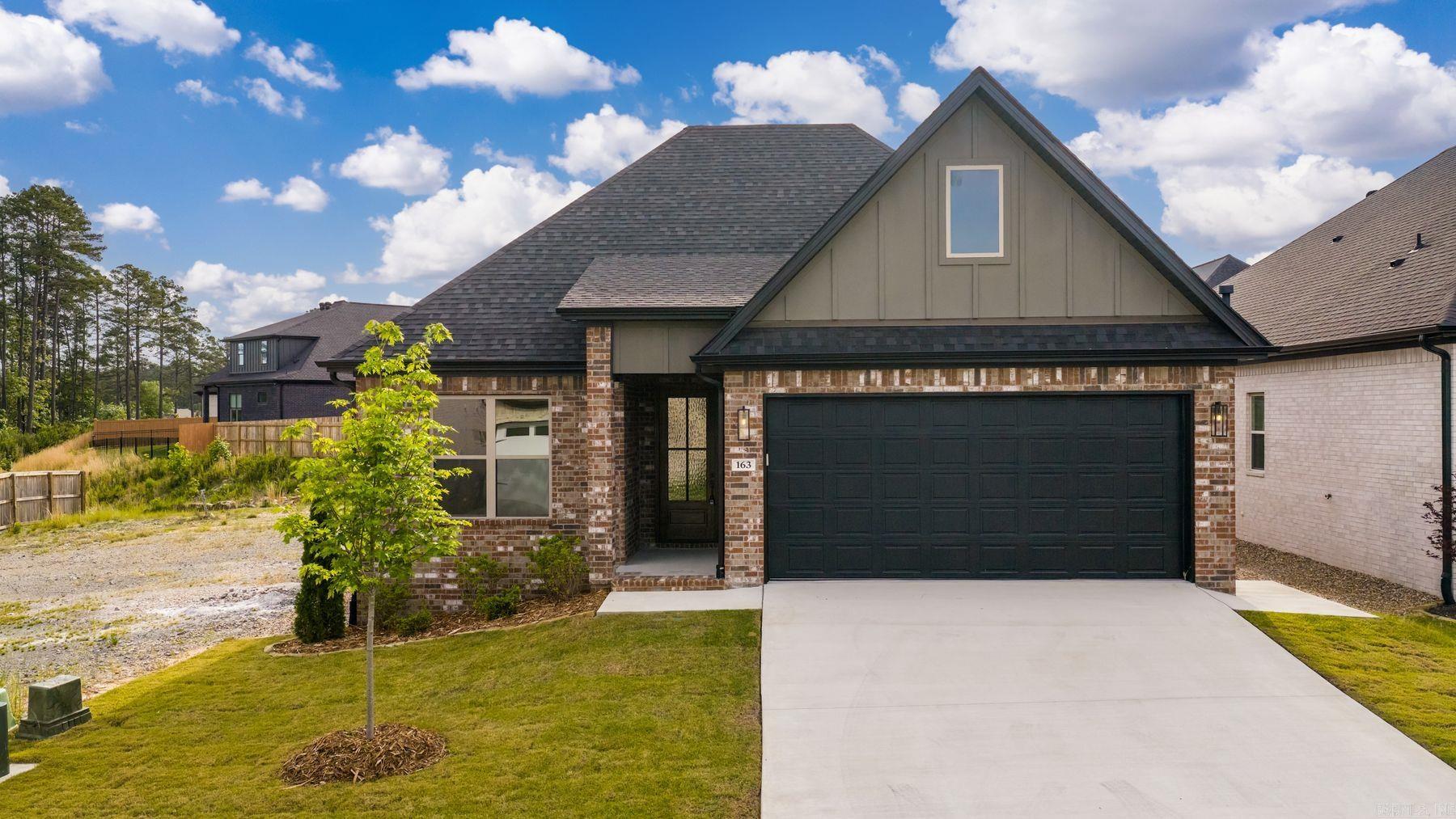 Welcome to 163 Fletcher Ridge Drive, a beautifully crafted new construction home in the desirable Fletcher Ridge community of West Little Rock. This thoughtfully designed 3-bedroom, 2-bathroom home offers modern comfort and quality finishes throughout. The open-concept layout features custom cabinetry, solid surface countertops, and a full suite of stainless steel appliances, including a gas cooktop, wall oven, and built-in microwave—perfect for both everyday living and entertaining. A spacious pantry closet provides added convenience and storage.  The inviting living area showcases a vented gas log fireplace, creating a warm and cozy atmosphere. The primary suite offers a private retreat with a tiled walk-in shower and stylish finishes. Additional highlights include a 2-car garage and upgraded energy-efficient features, such as foam insulation in the exterior walls for improved comfort and lower utility costs.  Built with attention to detail and quality craftsmanship, this home blends style, function, and efficiency. Don’t miss your opportunity to own a brand-new home in Fletcher Ridge!