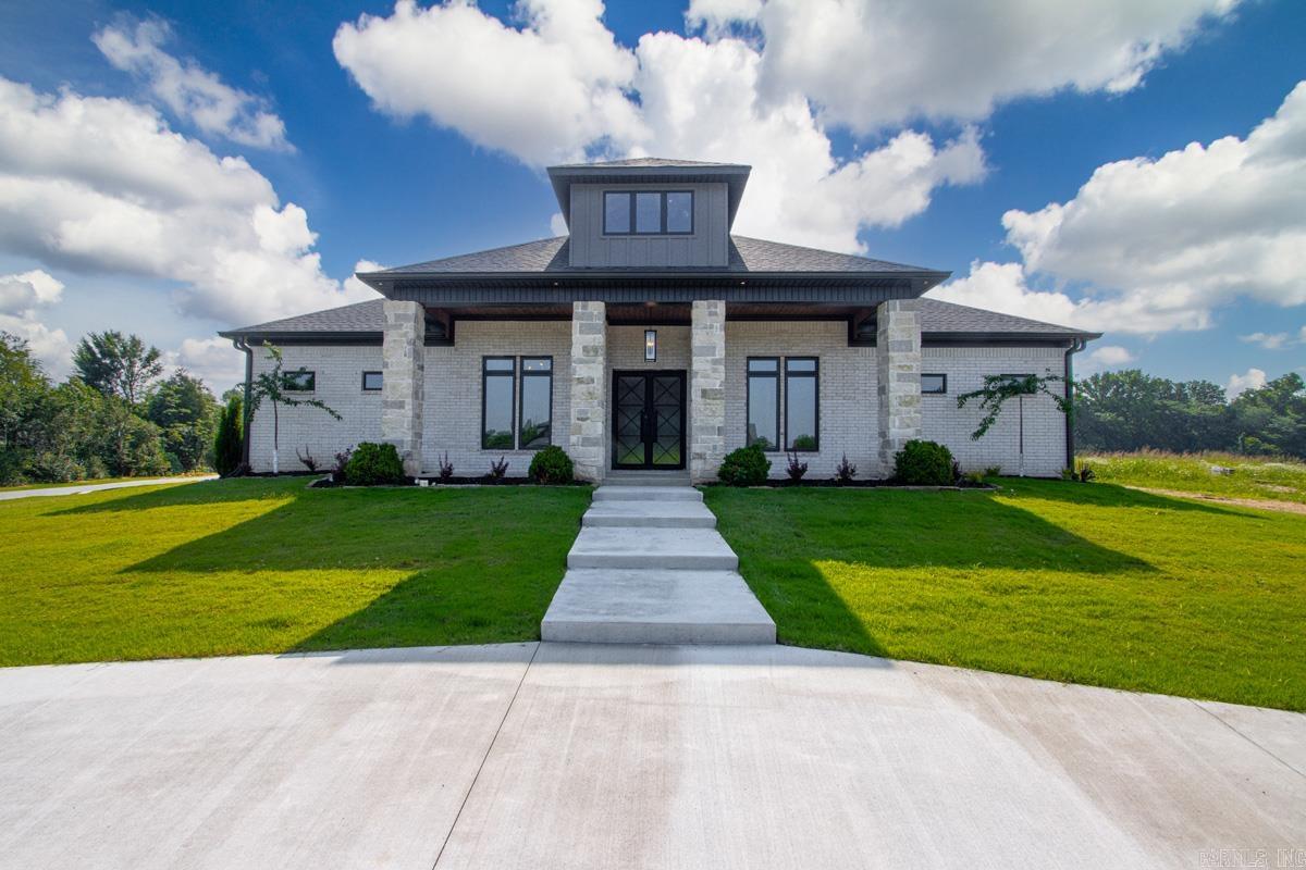 This is a must see!  This home is in one of the best new subdivisions in Saline County.  This home sits on a corner lot with a back load 3 car garage and a circle driveway at the front door.  The back porcheS (yes 2 porches) are amazing with tongue and groove ceilings and an outdoor fireplace to boot.  The landscaping is over the top with flower beds around more that half the home and a courtyard flower bed just as stunning. The inside has plenty of space for everyone with 4 bedrooms and a dedicated office with 3.5 bathrooms. The primary suite is its own wing with his and her closets and a huge bathroom.The laundry room is a great size with a spot for an extra refrigerator. The trim work is extensive with multiple accent walls and custom closets. The lighting is nothing short of spectacular, and the kitchen is to die for. With a huge double sided island, beautiful quartz countertops and backsplash to match.  A pantry able to hold all your family's groceries. The office is designed for any working professional with stained floating shelves and built in desk with granite countertops.  If you think this home sounds too good to be true you should see it, book your showing today!