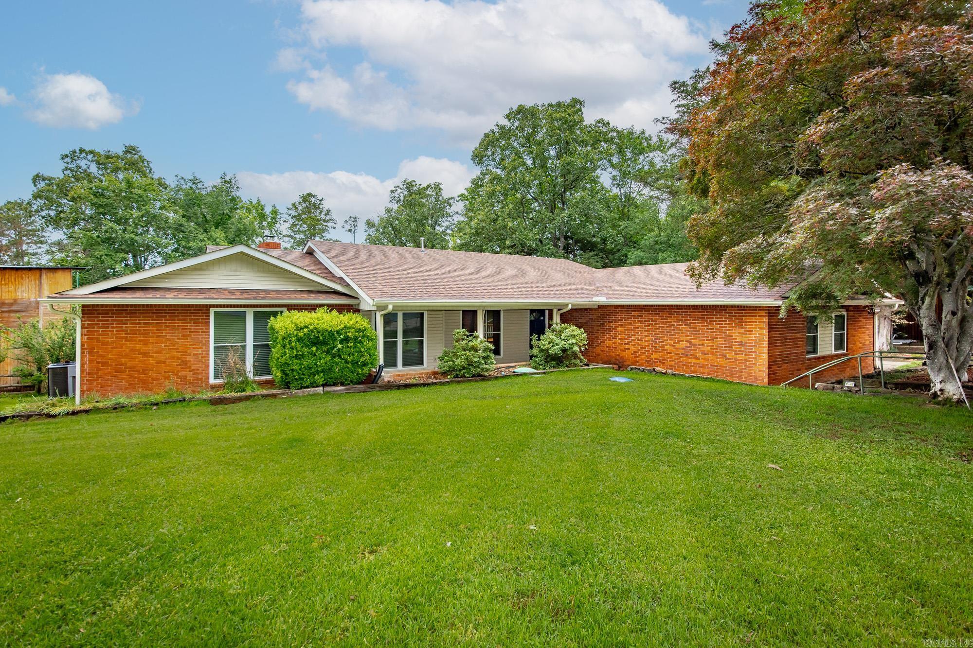 Welcome to the Market! Enjoy lakeside living in this beautiful brick home on the shores of Greers Ferry Lake. This spacious 4-bedroom, 2-bath home offers 2,470 sq ft of comfortable, open-concept living—perfect for family gatherings or hosting friends. Inside you will find a large kitchen with new granite countertops and backsplash, new carpet in the bedrooms, and fresh upgrades throughout, including a new roof, windows, and gutters and decking. The large laundry room adds convenience, while the separate master suite provides privacy and comfort. Relax by one of two fireplaces, or unwind in the screened-in porch overlooking the large backyard with an easy walk to the water. Located just 4 minutes from Devil’s Fork Boat Ramp and 2 minutes from the Narrows Boat Ramp, this home is ready for lake season—don’t miss your chance to see it!