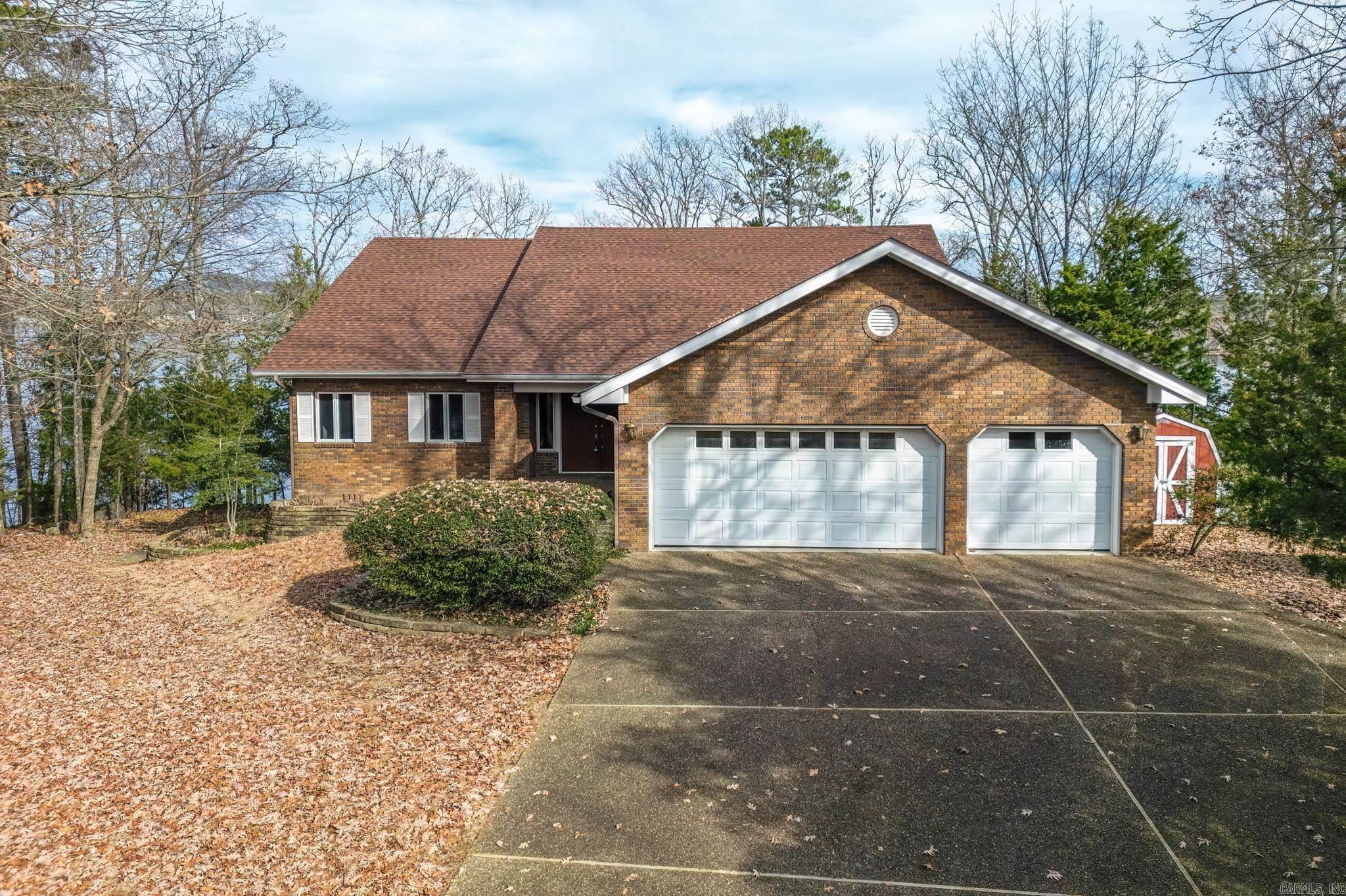 Lake Balboa waterfront with 220 feet of north/east facing shore on the Galeon Lane peninsula.  This brick home will allow you to live on the main floor with a vaulted ceiling in the living/dining/kitchen area.  Enjoy the lake view as you cook in the kitchen.  Walk in pantry/storage for all your entertaining needs. Fireplace in living room open to dining room.  There are two bedrooms with a primary bath between them.  Laundry room and a half bath.  Upper deck with screened porch for your outdoor enjoyment. The lower level features three bedrooms, full bath and a living area with a fireplace.  Many options for an office or hobby area.  Great space with inside and outside entrance for easy access to make a  a perfect room for a hobby/workshop area. & storage galore. This home is perfect for entertaining both inside & outside. Covered boat dock w/lift and swim deck are ideal for enjoying lake front living.  Water feature and patio.  Sprinkler system lake fed. Oversized garage with additional storage area.  No Sellers Disclosure. Agt rmks