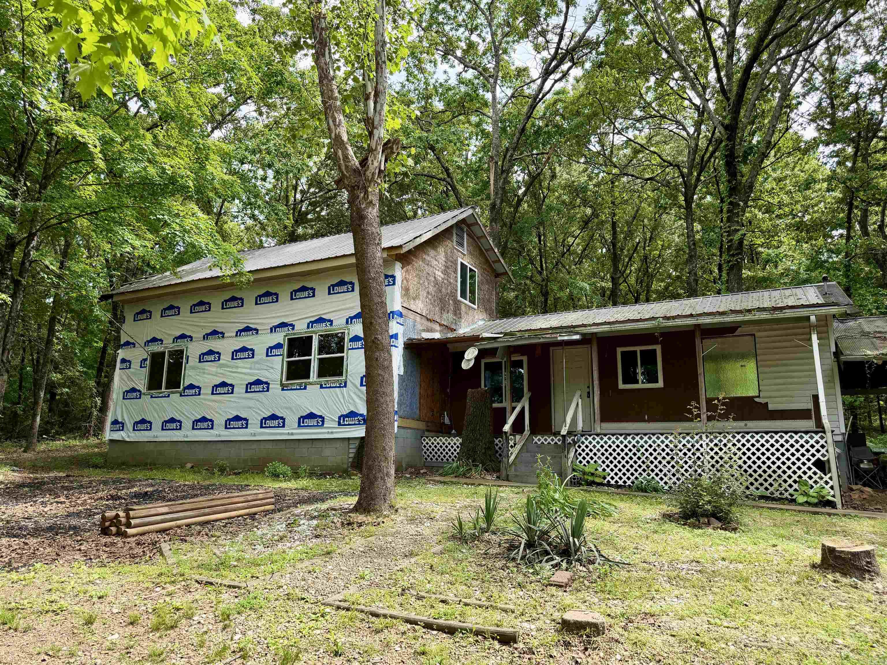 Many major improvements have already been completed including a new roof, updated interior, new windows, partial plumbing and electrical updates, plus new appliances and upper kitchen cabinets. Finish the remaining cosmetic details and siding to walk into instant equity while making the home your own. The spacious kitchen features stainless steel appliances, a butcher block breakfast bar, and pantry. Additional features include central heat and air with auxiliary gas heat, two water heaters, storage buildings, and a covered front porch perfect for enjoying the peaceful country setting near the Arkansas River. Outside you’ll find 1.78 acres with huge shade trees, plenty of room for a garden, and few nearby neighbors for added privacy.