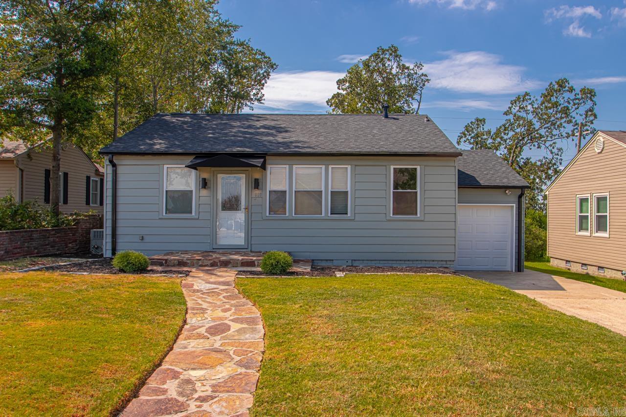 Freshly renovated with curb appeal to match! This Little Rock home features hardwood floors, an open kitchen/living/dining layout, and a freshly painted exterior. The kitchen offers solid cabinetry, updated countertops, and stainless-steel appliances. Bathrooms have been remodeled with modern tile and fixtures. A one-car garage, flat lot, and spacious backyard provide plenty of room for storage, entertaining, or outdoor living. Roof is less than two years old for peace of mind. Located just minutes from downtown, top-rated schools, and less than a block from Baker Park, this home blends thoughtful updates with a convenient location. Don’t miss it!  Currently tenant-occupied, leased at $1,800/mo (lease conveys). No showings without agreed sales contract.