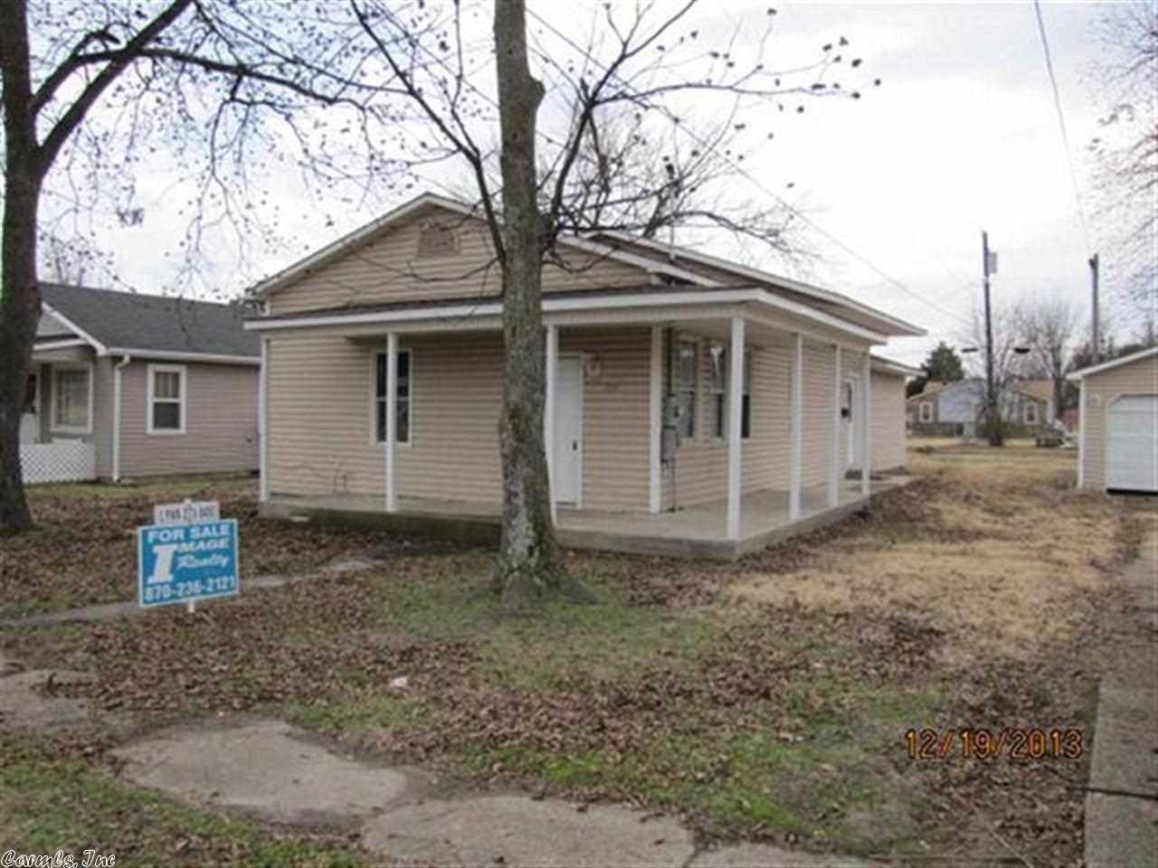 Cute 3 bedroom 2 bath home on a double lot in the small town of Piggott. Needs some floor coverings and other cosmetic repairs, but some renovations and upgrades have already been done including paint and fixtures. Sunken front room with vaulted ceiling that leads through french doors to the living room. Central HVAC and wrap around porch. Large 0.31 acre lot with detached 2 car garage with workbenches. Several pecan trees in front yard that made many buckets of pecans this year!