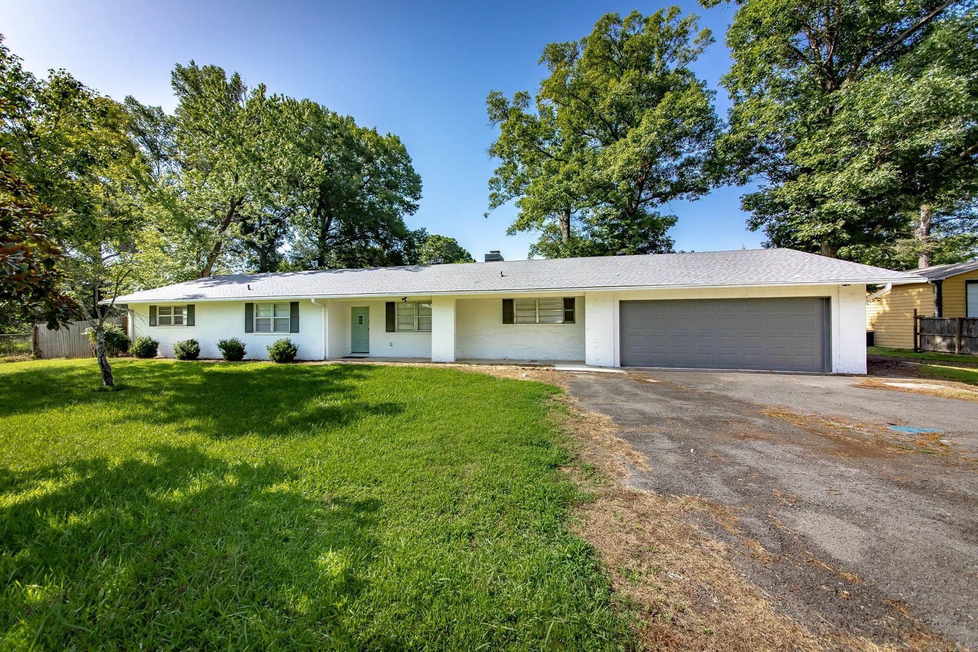 Welcome home to this beautifully remodeled 4-bedroom, 2-bath home situated on a spacious 0.69-acre lot! Step inside to a huge living room with a cozy brick fireplace, separate dining area, and an updated kitchen featuring gorgeous countertops, stainless steel appliances, and an oversized walk-in pantry. All four bedrooms are generously sized, while the primary suite boasts a custom walk-in tile shower. Outside, you'll love the covered back porch overlooking the large fenced backyard with mature shade trees and a fire pit—perfect for relaxing or entertaining. A 2-car attached garage plus a garage/workshop in the back provide plenty of room for storage, hobbies, or projects. This move-in-ready home combines modern updates with incredible space both inside and out!