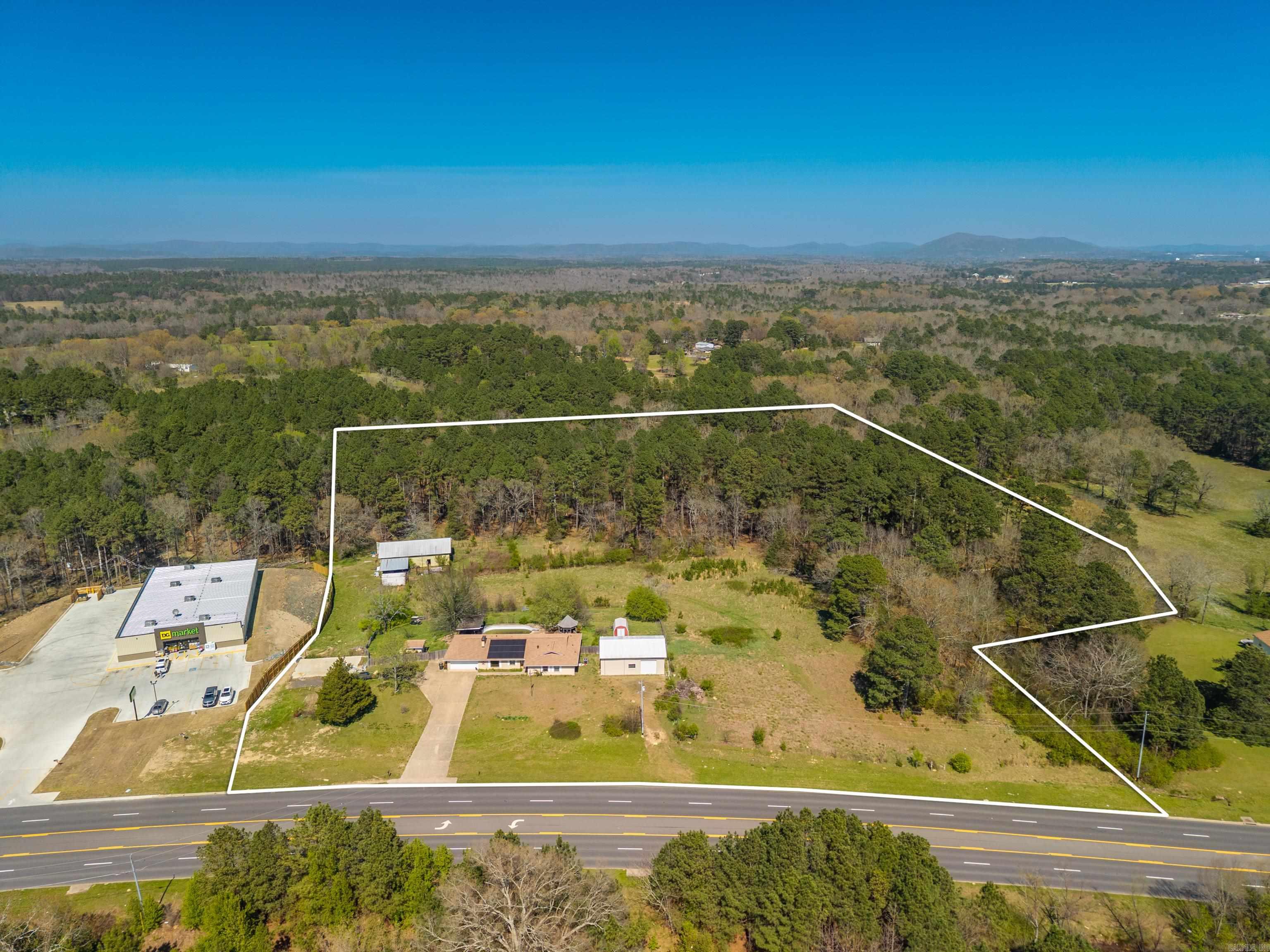 10.37 Acres with a brick house and 2 barns. The house is brick and has good bones, there is a 40X60 pole shed. There is a pool behind the house, needs new liner or can be filled. Can be sold either commercial or residential. There is a lot of visibility for any kind of business.