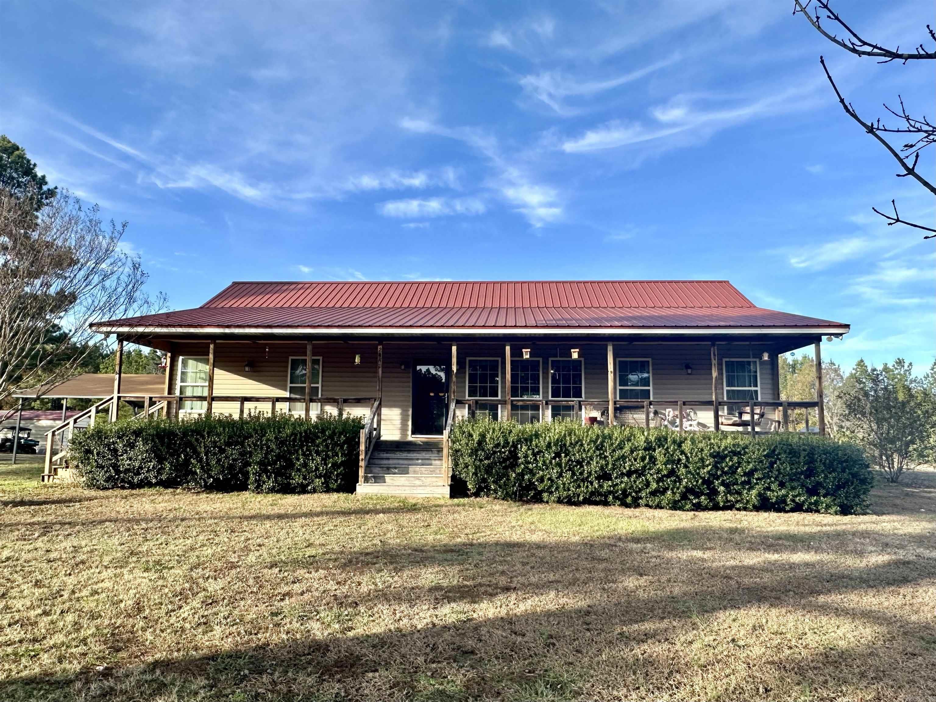 Discover a truly remarkable property with this incredible 3 bedroom, 2 bath home, nestled on 4.75 acres complete with highway frontage. Built in 2012, this home offers stunning features such as a walk-in shower in the primary bath and walk-in closets in the primary bedroom, along with a thoughtfully designed split floor plan for optimal privacy and functionality.  As you step inside, you'll be greeted by a spacious and inviting living area, perfect for entertaining friends and family. The open concept flows seamlessly throughout, connecting the living room, dining area, and kitchen, allowing for effortless socializing and gatherings.