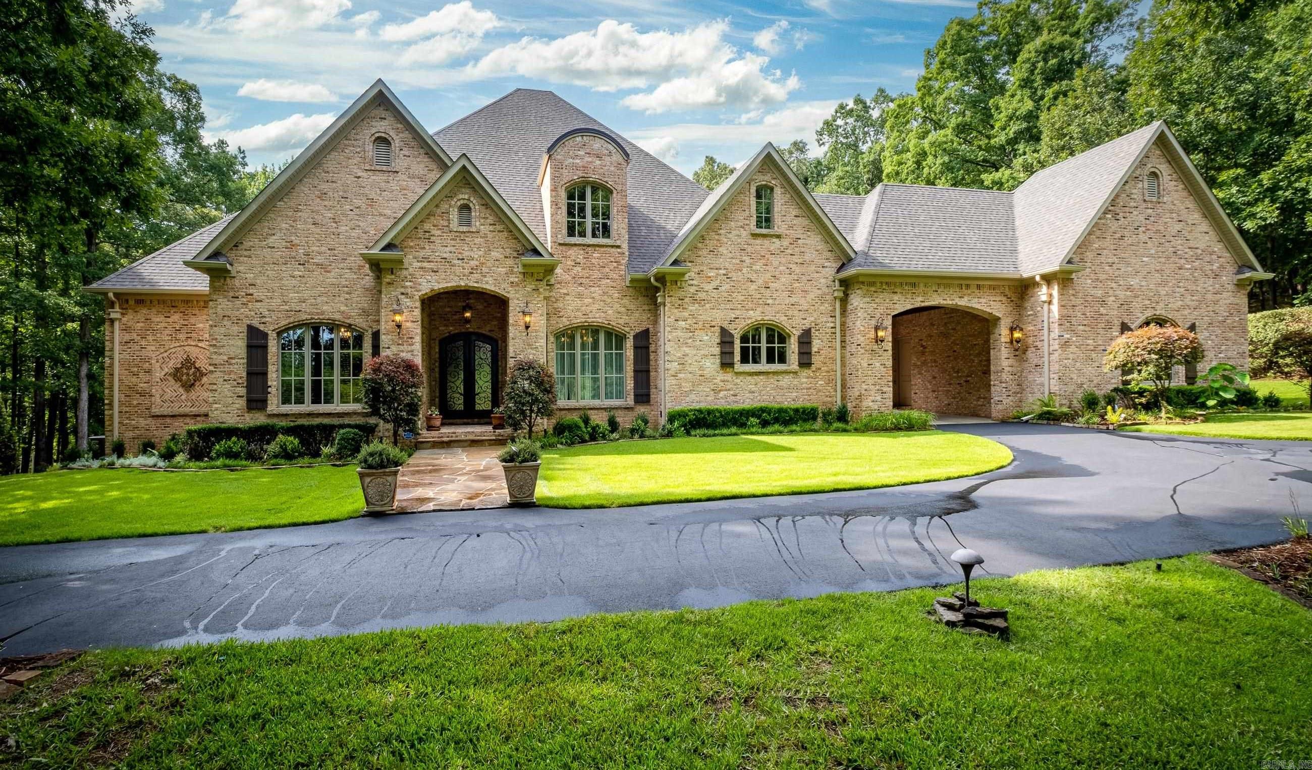 There is room for everyone in this 7,786-sf. home with 5 bedrooms, 5 full baths and 3 half baths. Working from home is no chore in the fully wood paneled office. Sports fans can invite all their friends to watch the big game in the oversized rec room with kitchenette and theatre space! Outdoor lovers can enjoy both outdoor living spaces, overlooking the inground pool. One area is perfect for al fresco dining and covered grilling while the other is set up with a fireplace and tv connection. Located on 5 lush acres in the gated community of Chenal Downs, it is only 5 minutes away from shopping and fine dining. Square footage is based on appraisal. AGENTS SEE REMARKS!