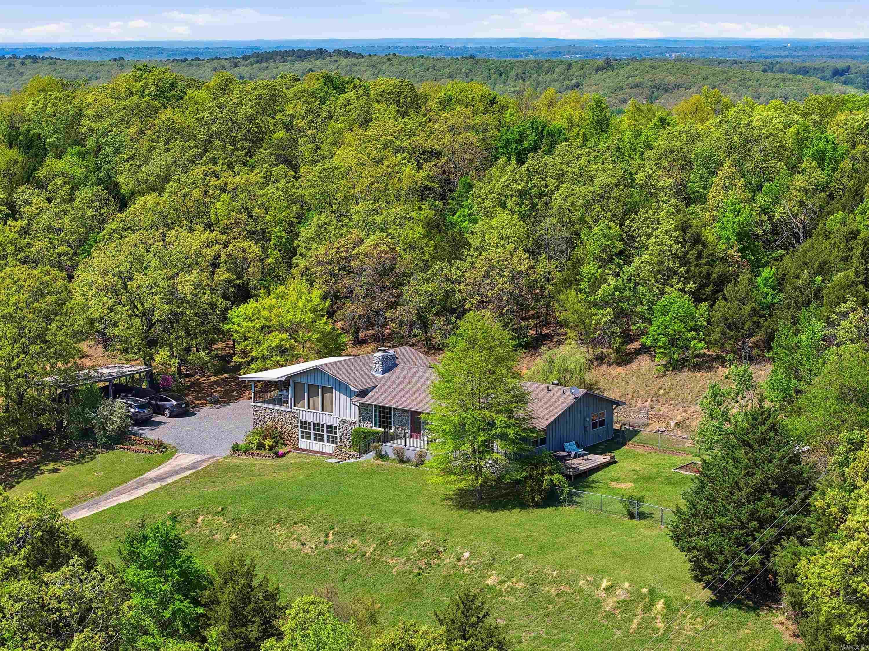 PRICE DROP + UPDATE ALLOWANCE! Don't miss your chance to see this one-of-a-kind home in person! Nestled on 5 wooded acres within Conway city limits, this 3,000+ sq. ft. tri-level home offers the perfect blend of privacy, nature, and convenience. A tree-lined driveway leads to a peaceful retreat just minutes from shopping, dining, schools, downtown Conway, I-40, and Conway Corp utilities. Inside you'll find 3 bedrooms, 2.5 baths, a formal living room, spacious den, sunroom, and a flexible lower-level bonus room with extra storage. The kitchen features new countertops, a large island with bar seating, pendant lighting, and generous prep space. Step outside to enjoy panoramic views from the covered porch, a shaded deck, gazebo, fountain, patio, morning coffee porch, wildflower overlook, and walking trails winding through approximately 5 acres of beautiful woods. Now offered with a price reduction and an update allowance, this is an incredible opportunity to personalize your dream home while enjoying unmatched seclusion and convenience. Schedule your private showing today!
