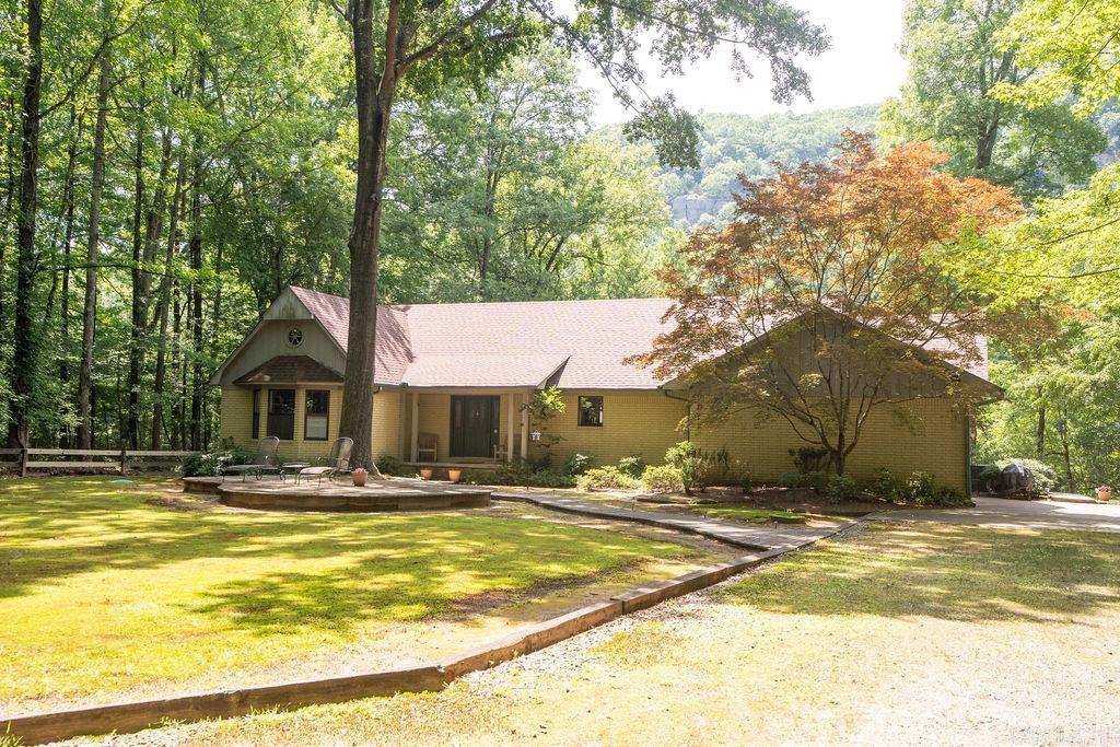 This beautiful home on the Little Red River offers serenity with over 2 wooded acres of privacy at the end of Wildflower Lane. It features 2 full "master " suites and 2 guest rooms, spacious decks and patios for outdoor enjoyment, a boat dock with electric boat lift located on one of the best streches of the River to fish, all with views of Libbby Bluff across the River. The open living/dining has a fireplace to warm you while you enjoy the views.The 2 car attached garage has permanent stairs to the attic and there is a large detached shop/garage for storing boats and lake and river toys. With over 200 feet of river frontage, you could possibly divide a 100 ft. lot to sell or if you would like to have more land there is an additional 8.1 acres available. Enjoy evenings around the firepit overlooking the river and to compliment the world class trout fishing the private subdivision lake is there for warm water fishing for bass, bream,etc. Fiber Optic internet service has been installed.Call today for your private showing.