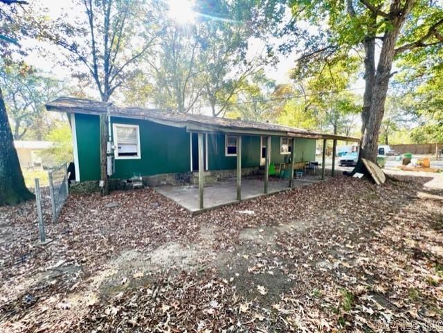 Convenient location. decent curb appeal, spacious living area and bedrooms, on a large level lot, with mature trees. Room to add a mobile home for additional rental income, or have a spacious backyard. House built around a mobile home. Previous tenants used space heaters and window units. Definitely needs work. Good potential for a 4/2 with 1500+ sq feet. Carport is deep for tandem parking or 1 car and a covered patio. Shed in back and property is partially fenced. See agent remarks!
