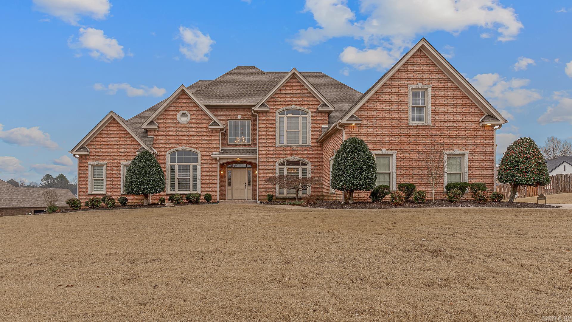 This inviting 4+ bedroom, 4-bath home blends space, style, and comfort with a layout designed to impress and live beautifully. From the moment you enter the two-story foyer and great room, the home feels open and welcoming, anchored by hand-scraped hardwood floors and thoughtfully designed gathering spaces. The main-level primary suite is a true retreat, complete with a screened porch and spa-like bath featuring double vanities, a whirlpool tub, glass-block marble shower, and a spacious dual-sided closet. Entertaining is effortless with a formal dining room with built-ins, a flexible formal living or office space, and a stunning island kitchen offering granite countertops, maple cabinetry, double ovens, ice maker, vaulted breakfast room, and a dry bar connecting the kitchen and dining areas. A guest bedroom with a full bath and laundry complete the main level. Upstairs, a loft with a Juliet balcony overlooks the great room, while additional bedrooms, a bonus room, and well-appointed baths provide room for everyone. Enjoy outdoor living on the stamped concrete patio, plus the convenience of a full three-car garage and two Marathon water heaters.