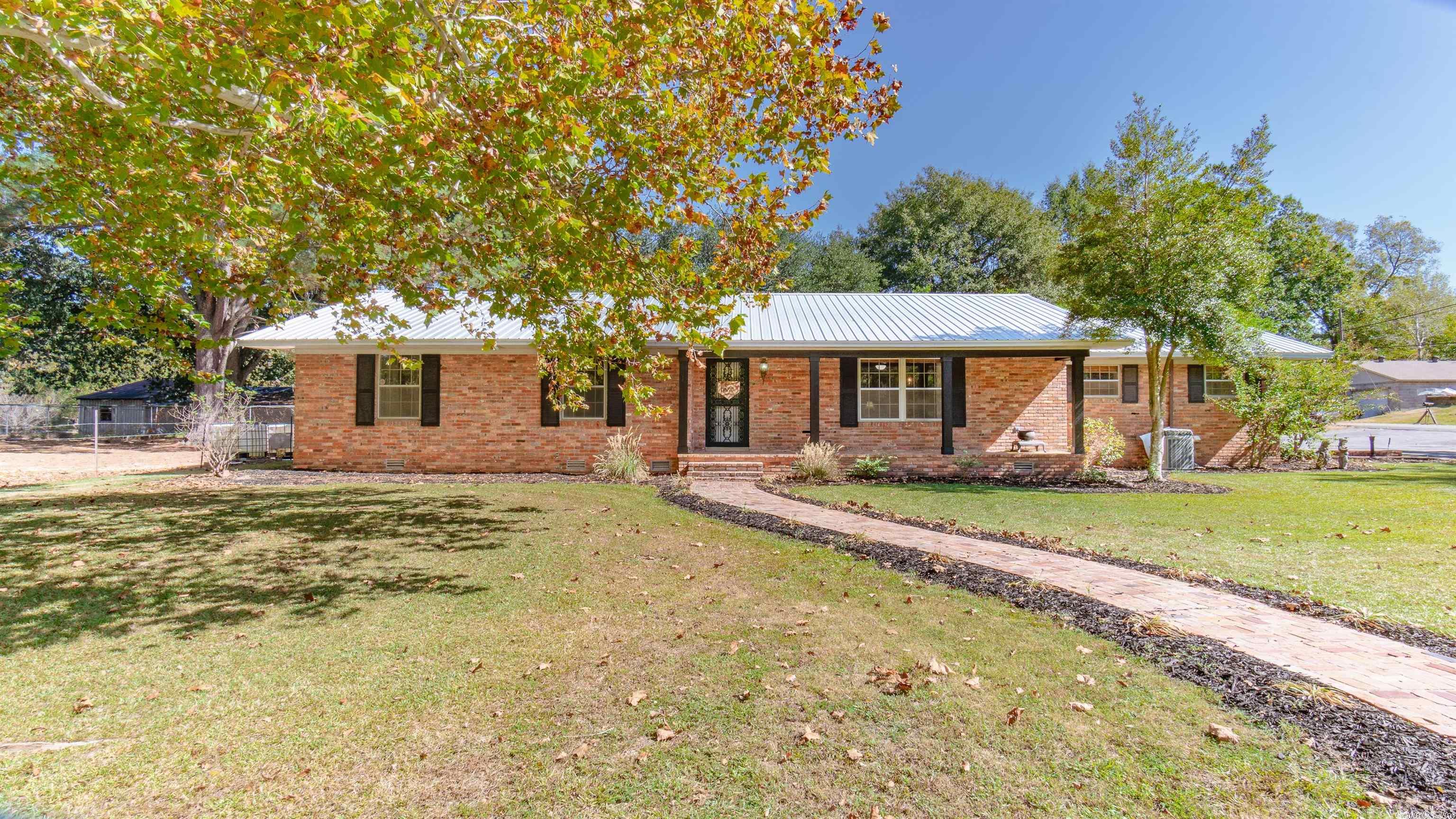 This charming home sitting on the hill has updates you are sure to be impressed with. New landscaping, fire pit area, covered patio, new carpet, and fresh paint. Large mudroom with built-ins connects to half bath, that then connects to an expansive laundry room. Although in city limits, Judsonia allows animals and livestock. Make the fenced-in area a place for pets, gardens, or remove the fence and extend the grassy yard. 4 minutes to Hwy 67/167 and 6 minutes to Searcy Wal-Mart.