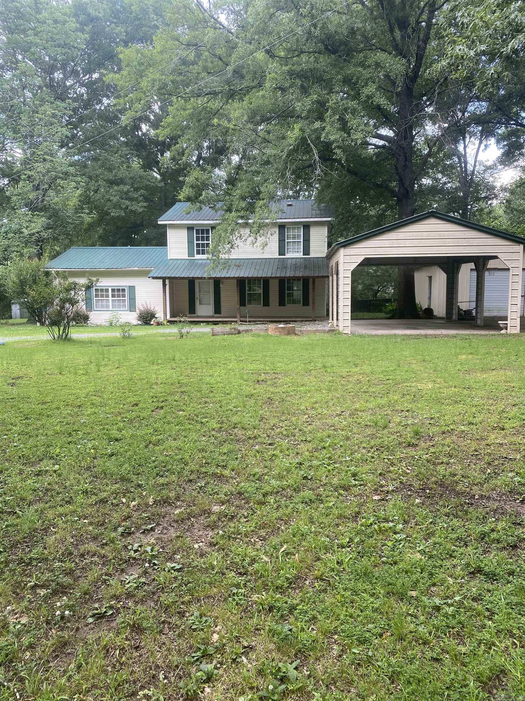 Opportunity awaits in a prime Bryant location! Situated on a private, gated 1.68-acre wooded lot within the Bryant School District and just seconds from Bethel Middle School, this property offers incredible potential for the right buyer. Featuring 4 bedrooms, 2.5 bathrooms, and plenty of space to make it your own, this home is ready for updates and renovations. Outside, you'll love the peaceful setting with mature trees, a large shop perfect for storage, hobbies, or projects. The home also includes covered parking for two vehicles and ample room for additional parking or recreational equipment.