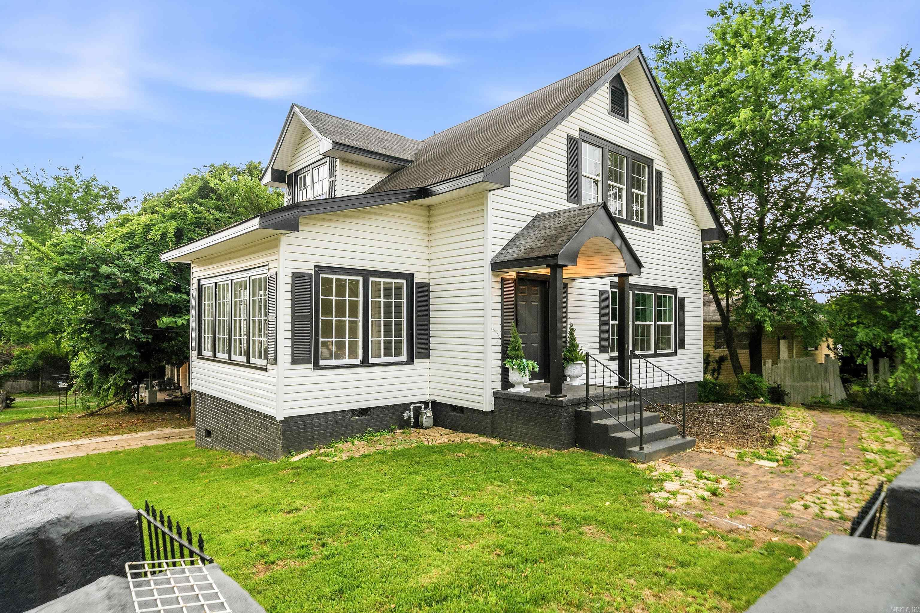 Beautifully restored 1938 historic cottage blending timeless character with  elevated aesthetics perfect for entertaining, working from home, or simply enjoying everyday living & long walks with your fur babies. This thoughtfully renovated home showcases original refinished soft pine hardwood floors, preserved stained glass accents, original doors and restored vintage glass doorknobs that honor the home’s architectural charm. A Light-filled sunroom with walls of windows creates the perfect sitting area, office, or flex space. Major improvements include all new plumbing, updated electrical, new HVAC units, new water heater, fresh interior and exterior paint, and many new windows throughout. The updated kitchen features quartz countertops, new appliances, and clean modern finishes while maintaining the home’s historic integrity. Renovated baths, beautiful natural light & preserved original details make this one-of-a-kind property truly move-in ready, virtually maintenance free. Conveniently located with easy access to dining, shopping, and business districts, this distinctive property offers the rare opportunity to own a piece of history without sacrificing contemporary convenience.
