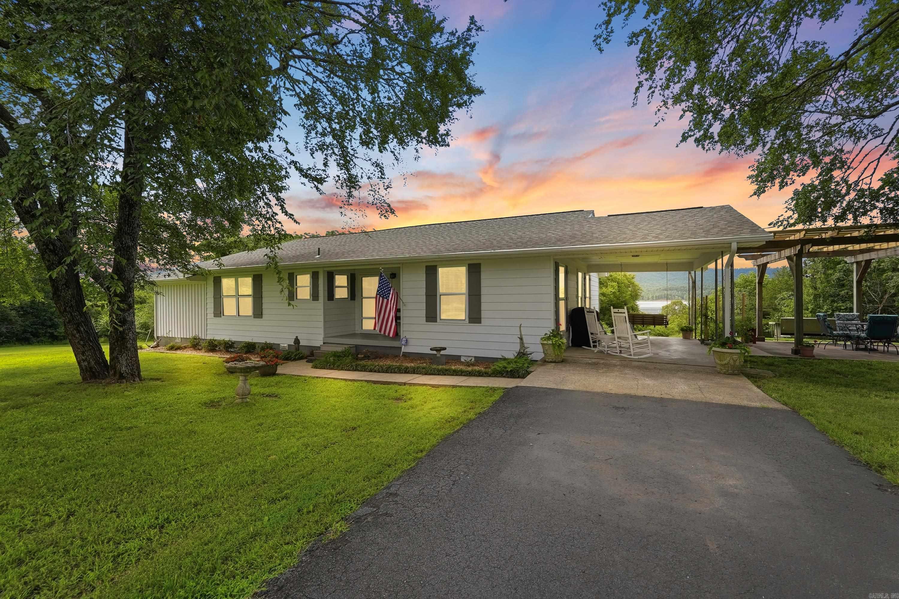 Lakefront. Lakeview. Privacy. This beautifully updated 4-bedroom, 3-bath home offers 490 feet of shoreline on Greers Ferry Lake and sits at the end of the road for peace and quiet. Walk to the water for a swim, launch your canoe or kayak, or drive just about a block to Choctaw Marina. Inside, you'll find room for everyone with a spacious living room, sun room and plenty of bedrooms for family and overnight guests. The screened porch is the perfect place to enjoy morning coffee while taking in the views and watching the local wildlife. Outdoor living is just as impressive with a 16' x 28' pergola, a 24' x 28' shop/boat storage with electricity and two automatic overhead doors, and plenty of space to enjoy the outdoors. Whether you're searching for a full-time lake home, weekend getaway, or vacation retreat, this property is ready to make lasting memories. Please see Associate Docs for Survey and List of Updates.