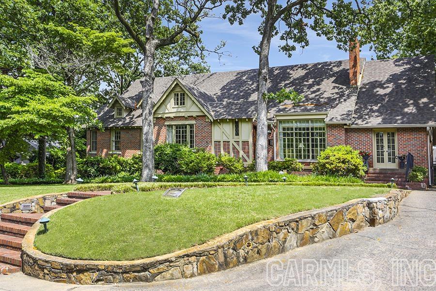 Gorgeous predominantly one level Tudor style in Prospect Terrace! Stunning cathedral wood paneled formal living room with oversized fireplace, gracious dining room and a large cozy den with fireplace!  Updated kitchen with wonderful light, walk in pantry, breakfast table space, and specialized cabinets. Primary bedroom on the main level with an updated bathroom (large walk in shower, stand alone vessel tub, and double vanity with gorgeous countertops). Walk in closet but the space where the bed lies presently can be a second, very large walk in closet if desired. Two other bedrooms with full baths on the main level . One bedroom contains beautiful bookshelves. Fourth bedroom and full bath away from other and above the laundry and one car garage. Gracious back flagstone patio with privacy. 130 foot wide lot, gorgeous Heights home!