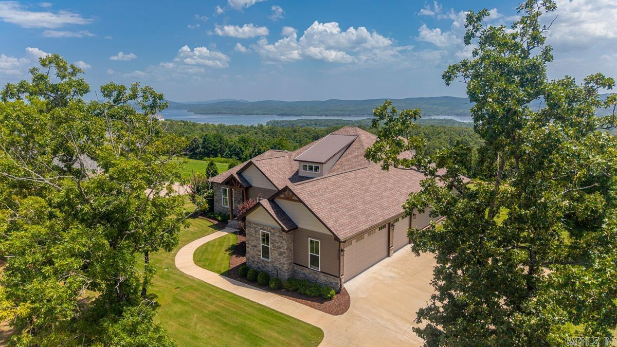 Stunning Craftsman-Style Home with Breathtaking Views in Lakeview West! Nestled in a prestigious gated community, this 4 bed, 4 bath home blends modern comfort with natural beauty. Set on 1.2 acres with spectacular views of Lake Maumelle and the Ouachita National Forest, enjoy unforgettable sunsets and a refreshing mountain breeze year-round. Beyond the scenery, you'll love the friendly neighbors and strong sense of community. Designed with an open floor plan, the home features upgraded engineered wood plank floors, custom cabinetry, and tile detailing throughout. The chef's kitchen includes a 36" built-in induction cooktop, abundant storage, and a custom walk-in pantry. Upstairs offers a large bonus room, bedroom, and full bath for added privacy. A multi-stage heat pump provides exceptional energy efficiency, while fiber internet offers the speed and reliability ideal for streaming, remote work, and everyday connectivity. The spacious yard, walking trails, and sports amenities complete this incredible property. Used only as a seasonal residence, this home shows like new and includes additional upgrades completed after closing. It's a MUST SEE!