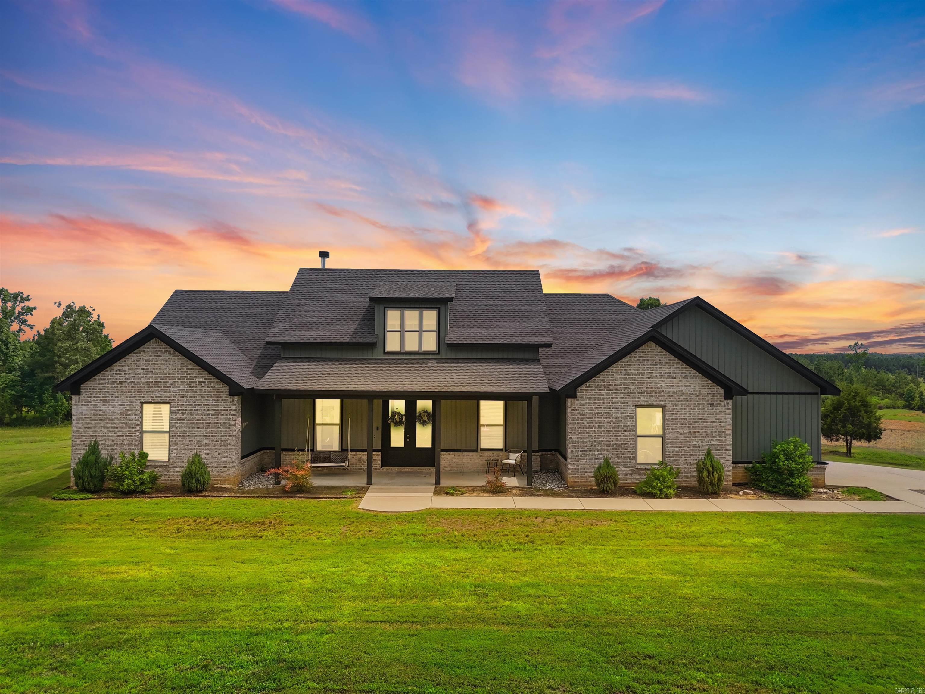 Elegance meets country charm in this exceptional 4 bedroom, 2.5 bath residence situated on nearly 2 acres of picturesque countryside. Offering more than 2,200 square feet of thoughtfully designed living space, this beautifully maintained home showcases custom cabinetry, granite countertops throughout, and a spacious owner's suite featuring a spa inspired tiled shower. The open concept design creates a seamless flow for entertaining, while soaring ceilings and abundant natural light enhance the home's inviting atmosphere. Outdoors, enjoy the privacy and serenity of expansive green space, a partially fenced area for pets, and energy efficient solar panels that help reduce utility costs. Blending refined finishes with peaceful surroundings, this property offers a lifestyle of comfort, sophistication, and modern country living.