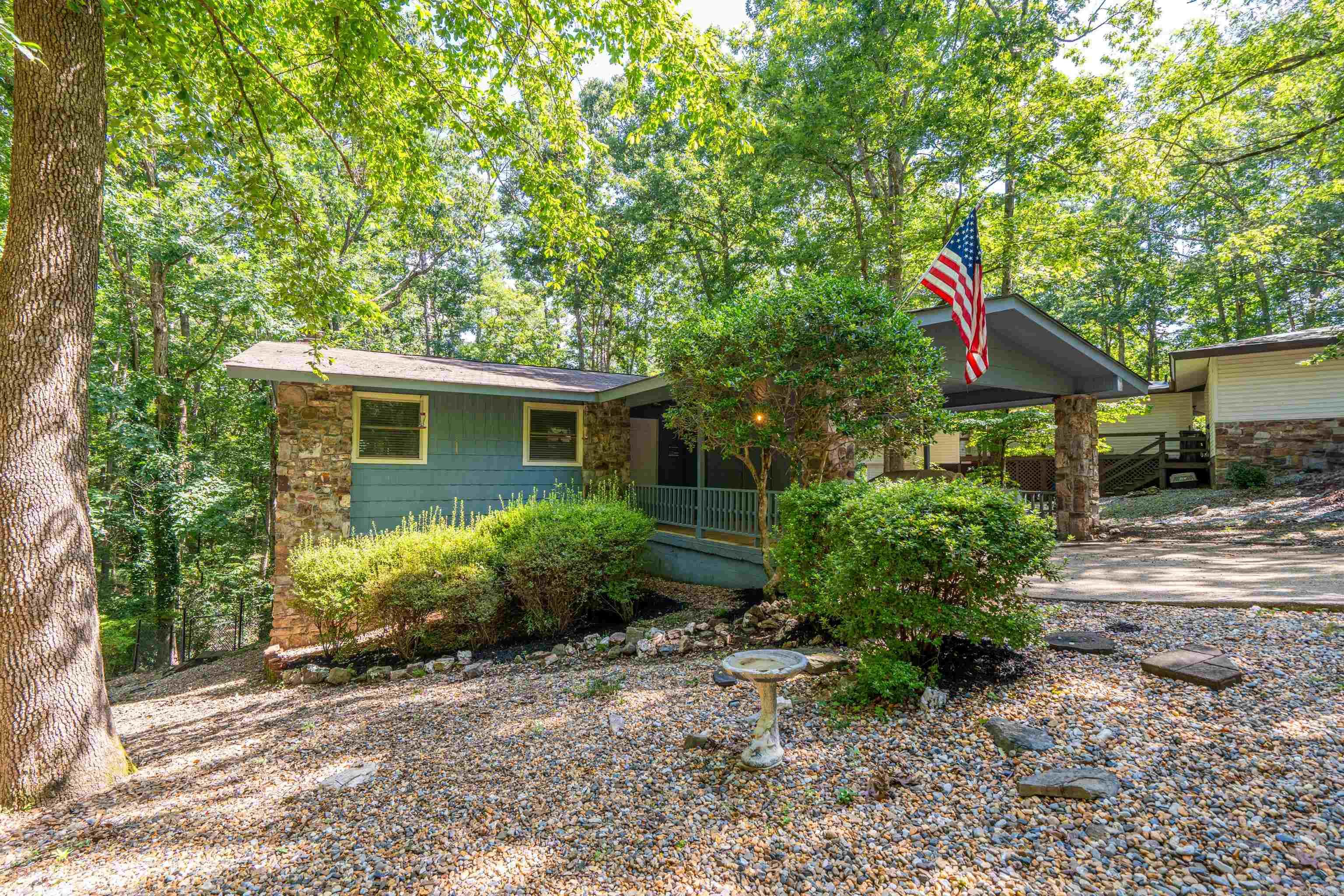 Experience affordable living in the nation’s largest gated community! Tucked away at the back of a quiet cul-de-sac, this beautifully updated home sits on an oversized, nearly 1/2-acre lot with a large fenced backyard. Whether you’re searching for a full-time residence, retirement home, vacation getaway, or investment property, this move-in-ready home checks all the boxes. The main level features a stunning kitchen with custom cabinetry, granite countertops, stainless steel appliances, including the refrigerator, and an inviting layout perfect for entertaining. Two fireplaces create warm, comfortable gathering spaces, while the Arkansas room and spacious screened porch offer peaceful views of the private backyard. The lower level includes a versatile den or game room, two bedrooms, and a beautifully updated bath with a spa-inspired tiled shower. An open patio, workshop room, abundant storage, and a two-car carport with storage closet add everyday convenience. Centrally located near the fitness center, golf courses, lakes, trails, restaurants, shopping, and all the premier amenities Hot Springs Village is known for. Last photos show area amenities.Call for your private tour!