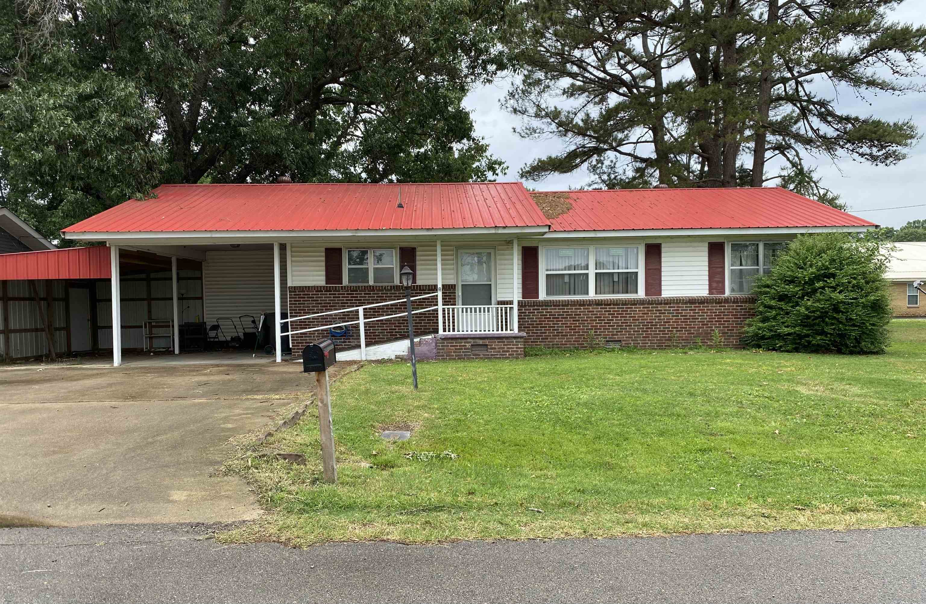 Three bedroom, two bath brick home located on a quiet street. This home features a large open kitchen and dining area with new floor covering, a utility and master bath combo, and some updated windows throughout the home. The HVAC was replaced in 2020 and the roof was replaced in 2023. Kitchen appliances include a new refrigerator and dishwasher.  Outside you will find a fenced backyard with plenty of shade, a small storage building, an attached carport, and an additional lean to for extra parking or covered storage. A great option for buyers looking for an affordable home with several important updates already completed.