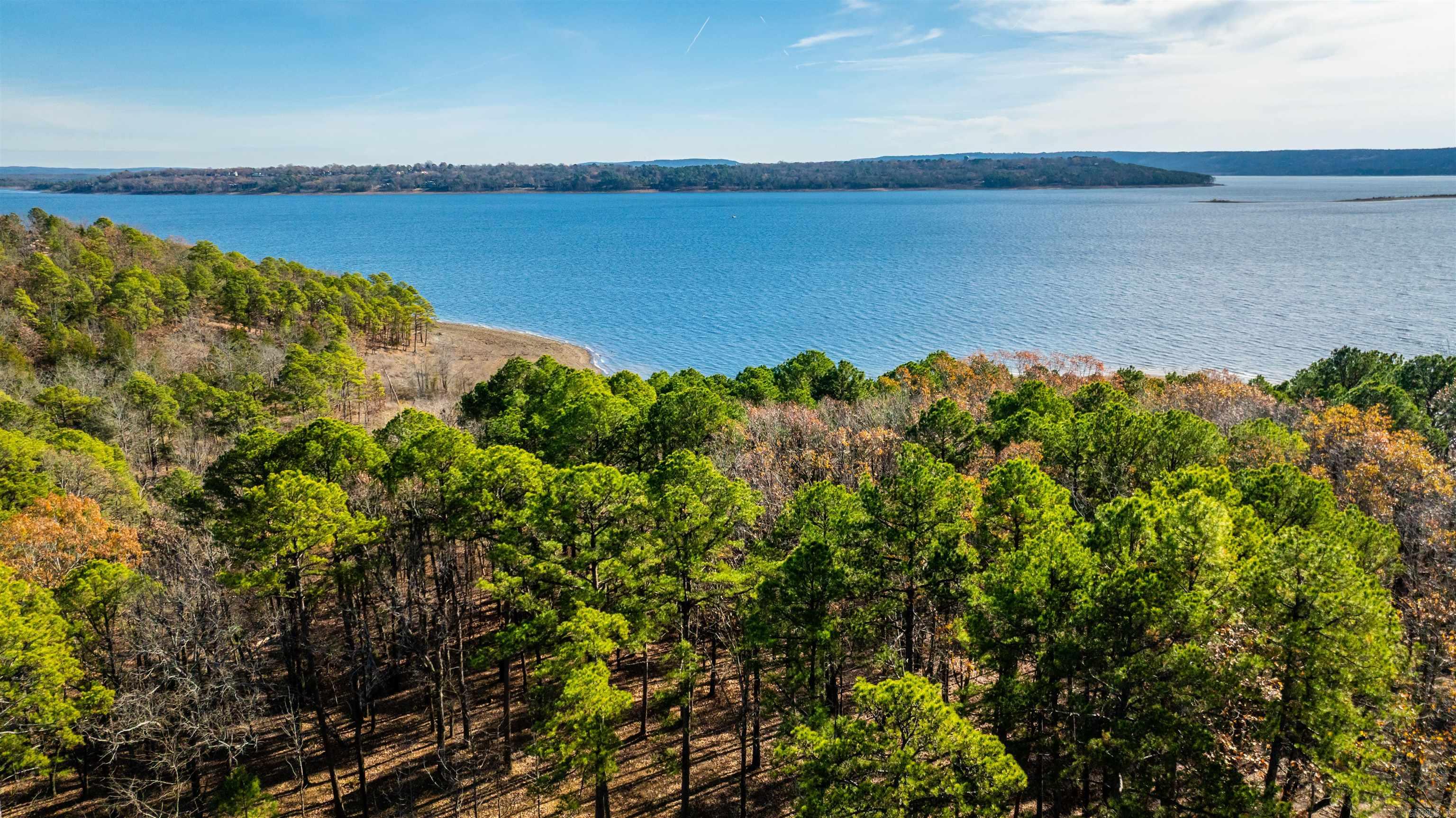 Don’t miss this rare opportunity to own waterfront property on Greers Ferry Lake—a highly sought-after find in this area. Tucked away on a quiet cove, this 0.43-acre lot with approximately 120 feet of lake frontage offers a peaceful setting for your future lake getaway or full-time residence.  Conveniently located just a 2-minute drive to the nearest boat launch, you’ll have quick and easy access to boating, fishing, and everything the lake has to offer. Electric, fiber optic, and water are available, making the building process more straightforward. Sewer system hookup is also available at an additional cost.   The property is also eligible for the owner to apply for a six-foot pedestrian path permit to the water, adding even more accessibility to this already exceptional lot.  Whether you’re looking to build now or invest for the future, this is a unique chance to secure a piece of waterfront land on one of Arkansas’s most desirable lakes. Taxes to be verified.