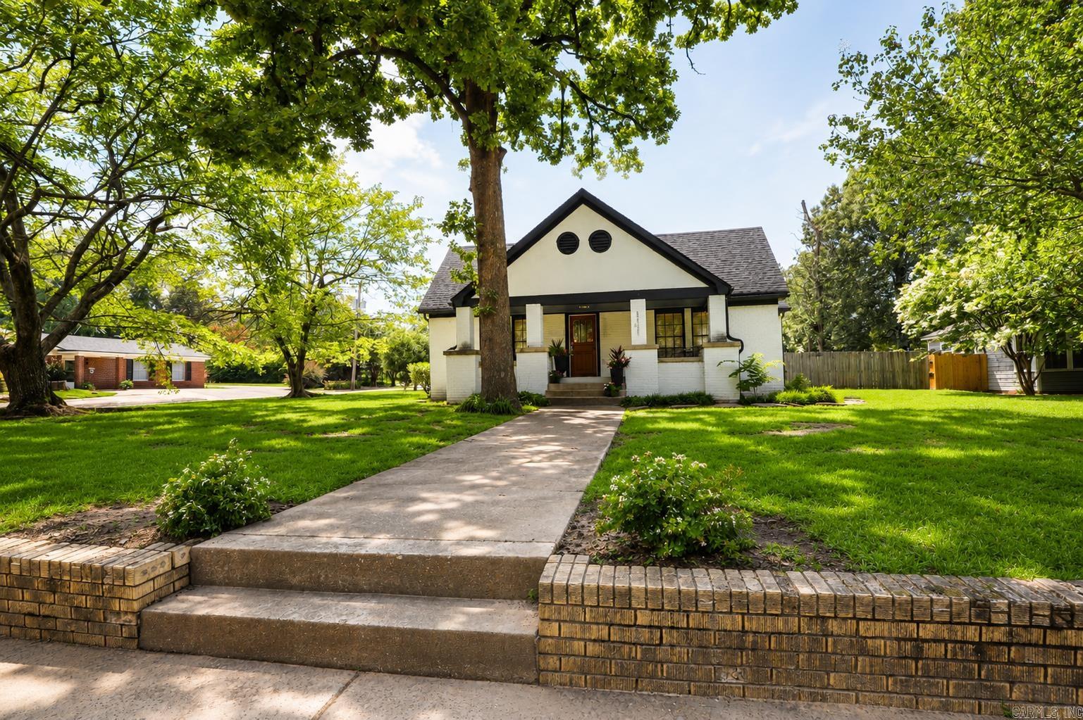 Step into timeless charm with this beautifully restored, move-in-ready historic home located in the highly sought-after Beech Street Historic District. Relax on the inviting front porch while enjoying views of the picturesque, tree-lined street, or entertain family and friends on the spacious covered patio overlooking the private backyard. Inside, you'll find a thoughtfully designed floor plan featuring four bedrooms, two updated full baths, two living areas, a formal dining room, and a sunny breakfast area. The stunning kitchen offers granite countertops, a gas range with four burners and a griddle, stainless steel appliances, a new dishwasher, and a pantry for added storage. The primary bath features a walk-in shower, while the updated hall bath includes a tub/shower combination with attractive tile finishes. Luxury vinyl plank flooring, original pine floors in portions of the home, and carpet in the upstairs bonus room blend historic character with modern comfort. Additional upgrades include central heat and air, an on-demand tankless water heater, repiped hot and cold water lines for excellent water pressure, and improved energy efficiency with additional blown insulation.