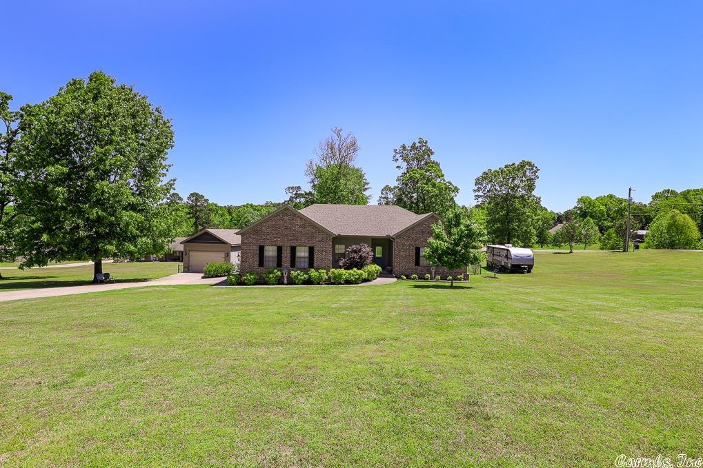This one is a show stopper! Beautifully updated, well cared for home, in absolute pristine condition. Large living area, separate dining room. Split bedroom arrangement and all bedrooms are generous in size. Wood, carpet and designer tile floor coverings. Homes sits on over an acre, manicured corner lot, fenced. Covered  deck expands the entire back. Whole house generator. 18x30 shop/separate garage. Nothing about this amazing place will disappoint! The island bar in kitchen does not convey.