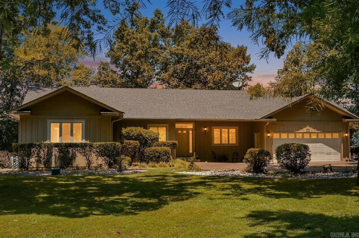 Nestled on a premier Lake Balboa street, this waterfront estate perfectly blends active lake living with unparalleled utility. This 4 bedroom, 3 bath layout includes a private home office and shines with new luxury vinyl plank flooring and a crisp, modern paint palette. Updates on bathrooms stand out as well. Outside, a near level slope brings you just steps away from the water's edge and your own private boat dock. The true crown jewel is the incredible 336 sq.ft. finished workshop with entrances from the home and a private one outside. Enjoy the ideal Hot Springs Village lifestyle where luxury meets functional design.