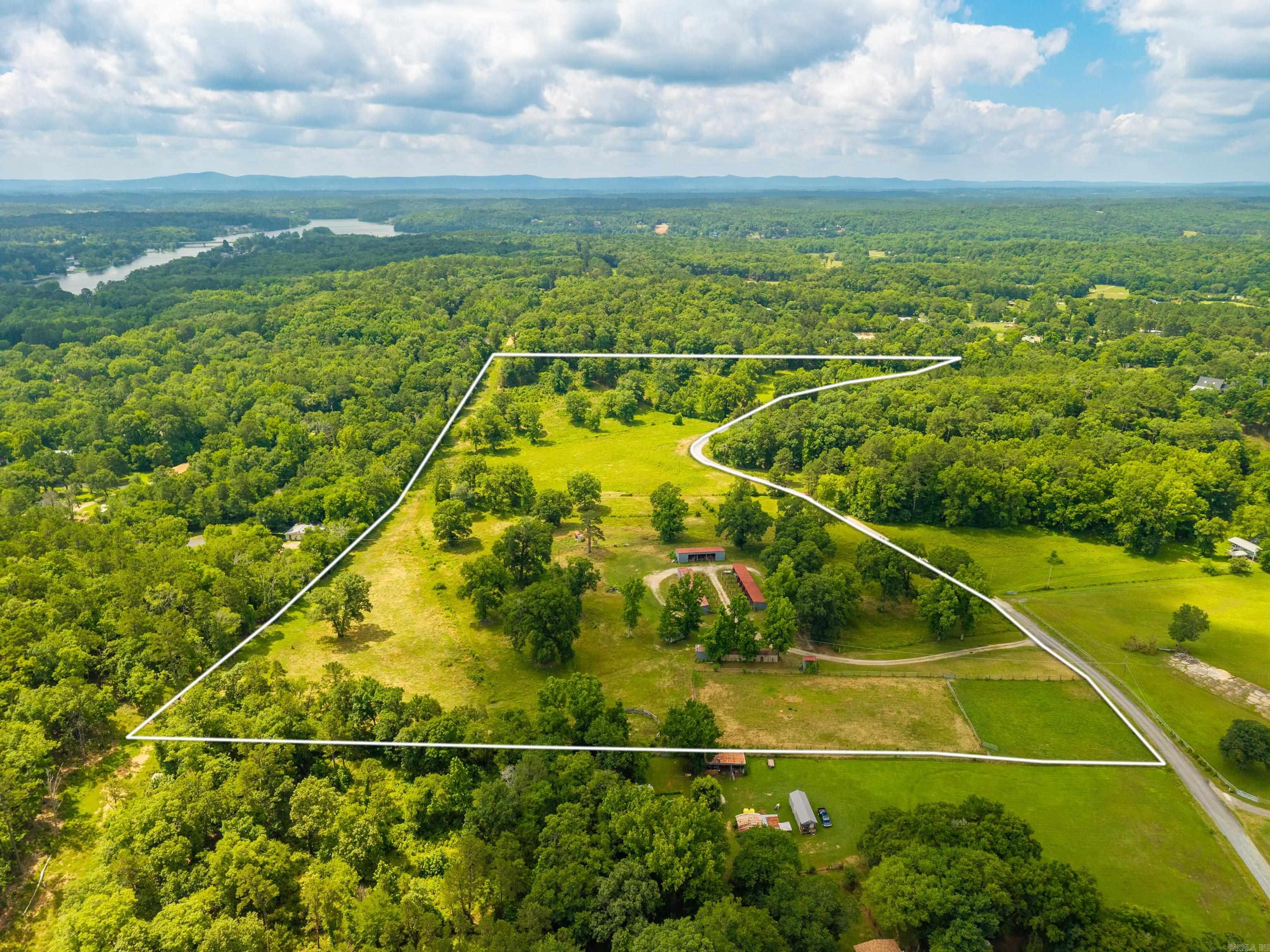 Calling all horse lovers!! Discover this rare opportunity to own 25-acres in Royal, Arkansas, just minutes from beautiful Lake Ouachita.  This fully cross-fenced property features a well-equipped pole barn and 16 separate stalls, offering ample space for boarding, training, or personal use. There is a designated area for a riding arena and even a pond that's yours to stock!  Whether you're looking to establish a horse operation, create a private ranch retreat, or enjoy peaceful country living with room to roam, this property offers endless possibilities.
