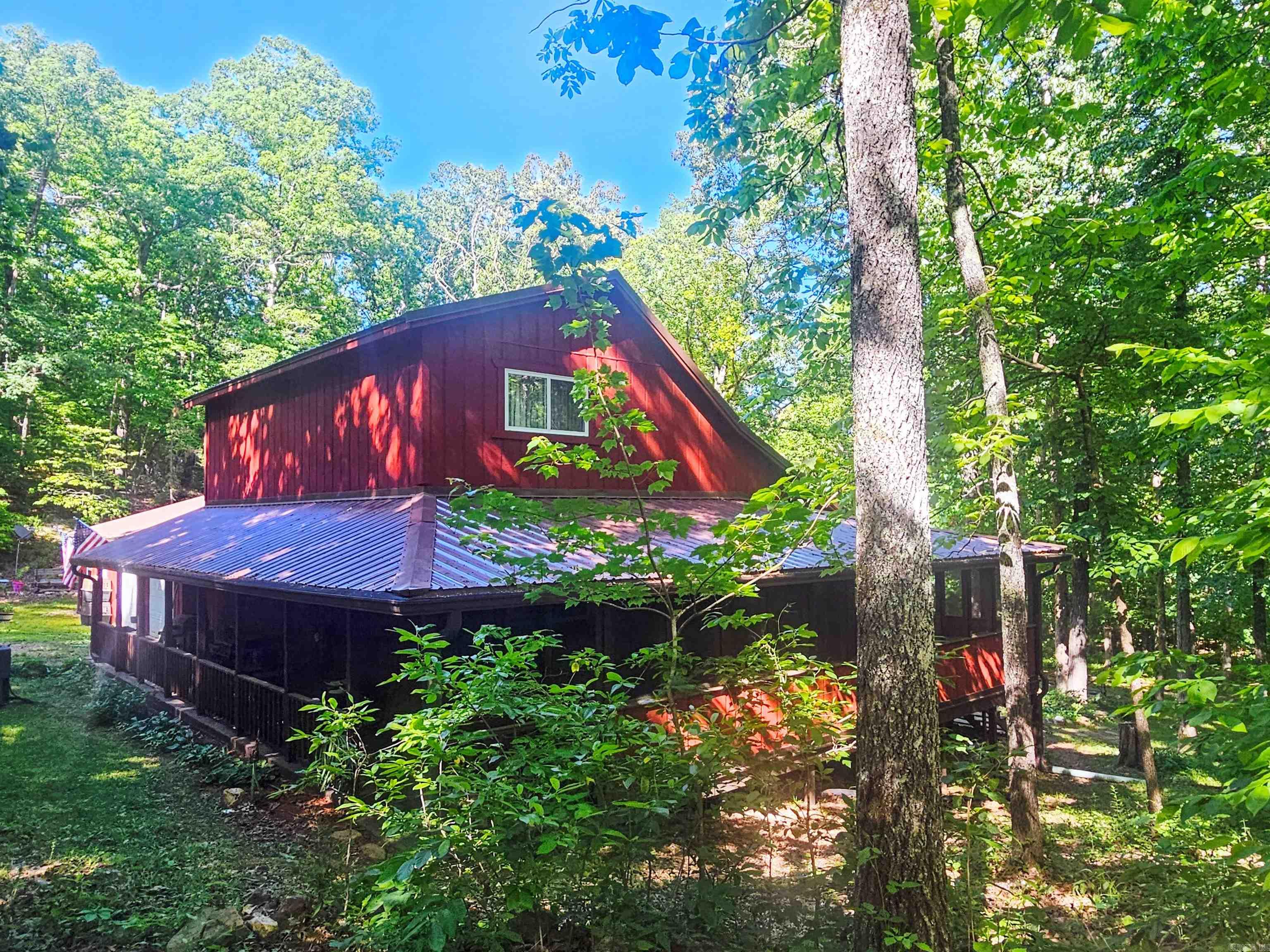 Hidden from the main road & tucked deep in the Ozark woods, but still close enough to town to enjoy deliveries!  Just 7.5 miles from downtown Mt View, the Folk Music Capital of the World. This beautifully maintained 3BR, 3.5BA home on 13.48 wooded acres offers privacy, comfort, and country living at its finest.       Oversized windows overlook a gorgeous park-like backyard retreat filled with mature hardwoods & natural beauty. Inside you’ll find soaring ceilings, warm wood accents, spacious living areas, & a comfortable layout ideal for everyday living or gathering with guests, also handicap adaptable spaces.       Features include ample storage, attached 2-car garage with attic space, attached heated workshop, large screened-in back porch, & trails winding through the woods for exploring & enjoying the peaceful setting.     Enjoy nearby attractions including live folk music on the Mountain View square, Ozark Folk Center, Blanchard Springs Caverns, White River fishing, hiking, & Ozark adventures.     A rare opportunity to own a secluded, well-built home surrounded by nature while remaining close to town amenities.      Search: mountainviewarkansas.com