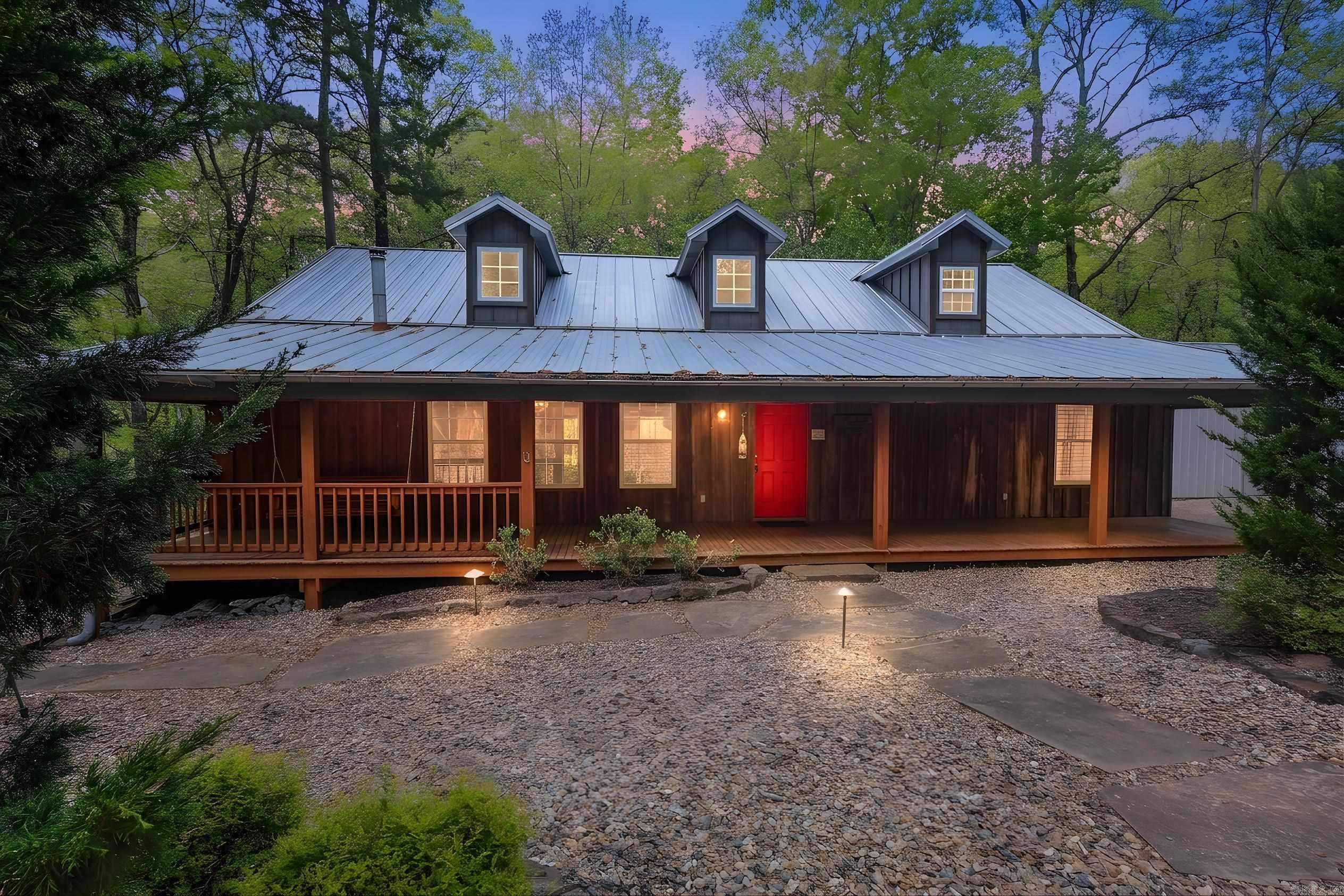 Versatile property designed to accommodate up to 16 guests, located just minutes from Lake Ouachita. The main home offers approximately 2,024 sq ft with 2 bedrooms, a lot that sleeps 4, and 2 bathrooms, featuring vaulted ceilings, wood floors, a dry bar, and a well-equipped kitchen with stainless steel appliances, granite countertops, and a warming drawer. Enjoy a screened porch, outdoor fireplace, and landscaped front entry with a concrete drive and water feature. Property is selling partially furnished.   A separate 1,003 sq ft casita provides additional space for guests, bringing the total sleeping capacity to 16.  The property also includes a 1,068 sq ft heated and cooled 3-car garage with an additional washer and dryer hookup, plus a 450 sq ft foam-insulated, climate-controlled single garage—ideal for storage, hobbies, or lake gear. Generator-ready electrical is in place (generator not included).  Conveniently located approximately 4 miles from Mountain Harbor, 4.9 miles from Crystal Springs Recreation Area, and 22 miles to Hot Springs. Property is subject to some restrictions.