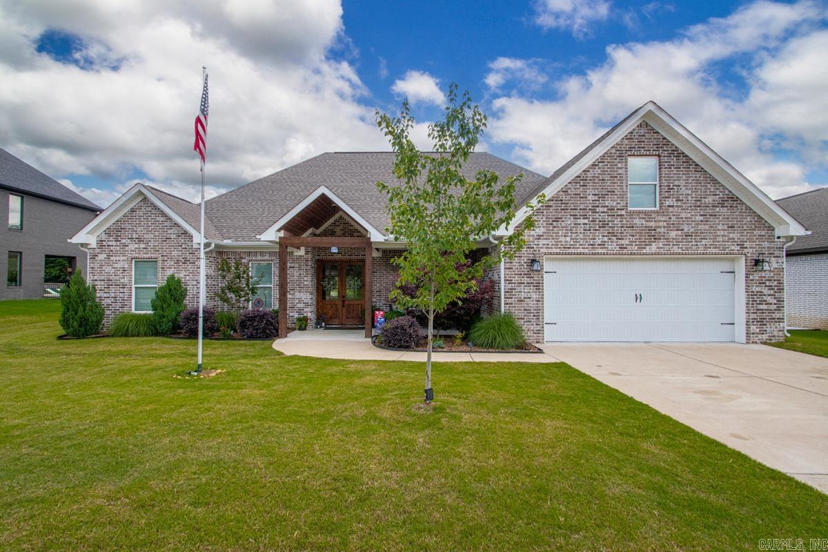 Welcome to a tranquil waterfront retreat in prestigious Hurricane Lake Estates. This beautifully upgraded 2,932-sq-ft home offers 3 bedrooms, 2.5 baths, and a spacious bonus room with dedicated HVAC that can serve as a 4th bedroom, office, or studio. The interior features wood-look tile floors, refined finishes, an oversized pantry, and exceptional storage, including a large walk-in attic. The resort-style backyard is designed for luxury living with an 18' x 36' heated saltwater pool with tanning ledge. A covered porch with gas fireplace, pergola and gazebo offer multiple outdoor living and entertaining spaces. The fenced yard is professionally landscaped with Japanese maples and crepe myrtles, creating year-round beauty and privacy. Enjoy serene lake views and the rare convenience of fishing directly from your shoreline. Community amenities include pickleball and tennis courts, a pool with splash pad, playgrounds, and walking trails. Located minutes from shopping, dining, top-rated schools, and easy access to Little Rock, this home offers the perfect blend of elegance, comfort, and convenience.