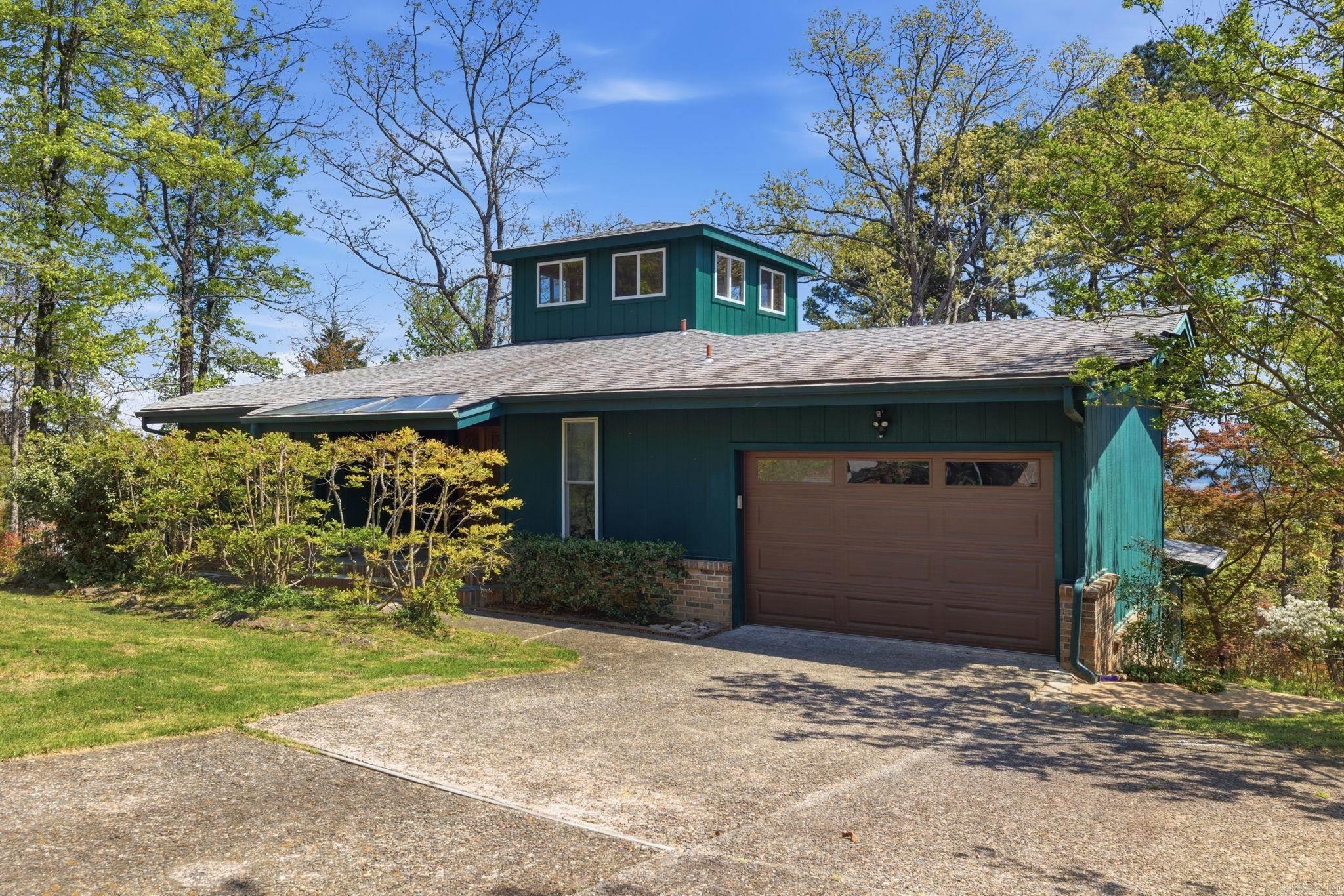 Wake up to magnificent year-round views of Greers Ferry Lake in this thoughtfully updated home designed for comfort, efficiency, and flexibility. The main level features a primary suite, sun-filled living areas, main-level laundry, and a kitchen with solid hickory cabinetry, pull-out lower drawers, walk-in pantry, and excellent storage throughout. Major updates include roof, windows, HVAC (2025), tankless water heater, baths, lighting, plumbing fixtures, paint, and flooring—giving full-time buyers confidence that key systems are already addressed. A propane fireplace with blower and passive heating and cooling design support year-round efficiency. The spacious lower level offers a family room, office, sauna, utility space, and extensive storage flexibility. A detached all-glass workshop captures the view and provides ideal space for art, hobbies, or remote work. Fairfield Bay offers marina and lake access, hiking and ATV/UTV trails, golf, tennis, pickleball, pools, dining, and year-round recreation. HOA package includes trash pickup, sewer, grinder pump insurance, road maintenance, and amenity access. Whole-house generator tied to owned LP tank adds peace of mind.