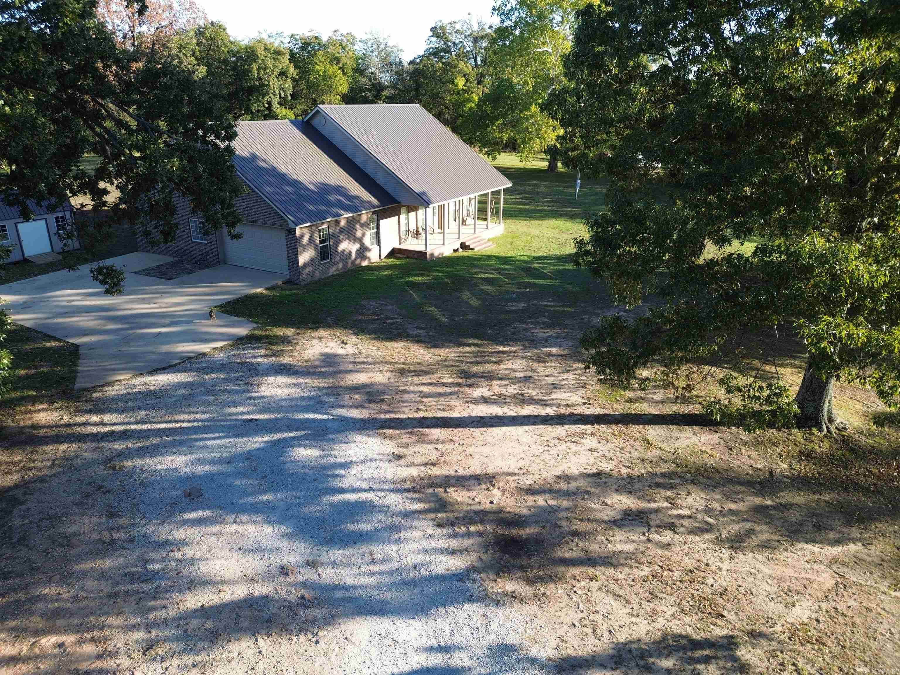 Conveniently located within the city limits of Marshall, this spacious 3-bedroom, 2.5-bath home sits on approximately 10+/- acres, offering privacy while remaining just minutes from schools, shopping, and local amenities. The open-concept living, dining, and kitchen area features vaulted ceilings and custom oak cabinetry, creating a bright and welcoming space. Primary suite includes a private bath with walk-in shower, jetted tub, and a large walk-in closet. Recent updates include new flooring in main living areas (2025), first-floor HVAC (2025), and new metal roof (2025). Water heater, refrigerator, and dishwasher replaced approximately 2 years ago. A bonus room above the two-car garage with half bath provides flexible space for guests, crafts, or a home office. Exterior features low-maintenance brick and vinyl/aluminum siding, soffit, and fascia. Covered front and back porches offer relaxing outdoor spaces to enjoy the scenic surroundings. 15 minutes to the Buffalo National River for fishing, kayaking, canoeing, and numerous outdoor activities, and 1.5 hours from Branson, MO, this move-in ready home combines modern comfort, outdoor lifestyle, and country charm. Don't miss out!!!