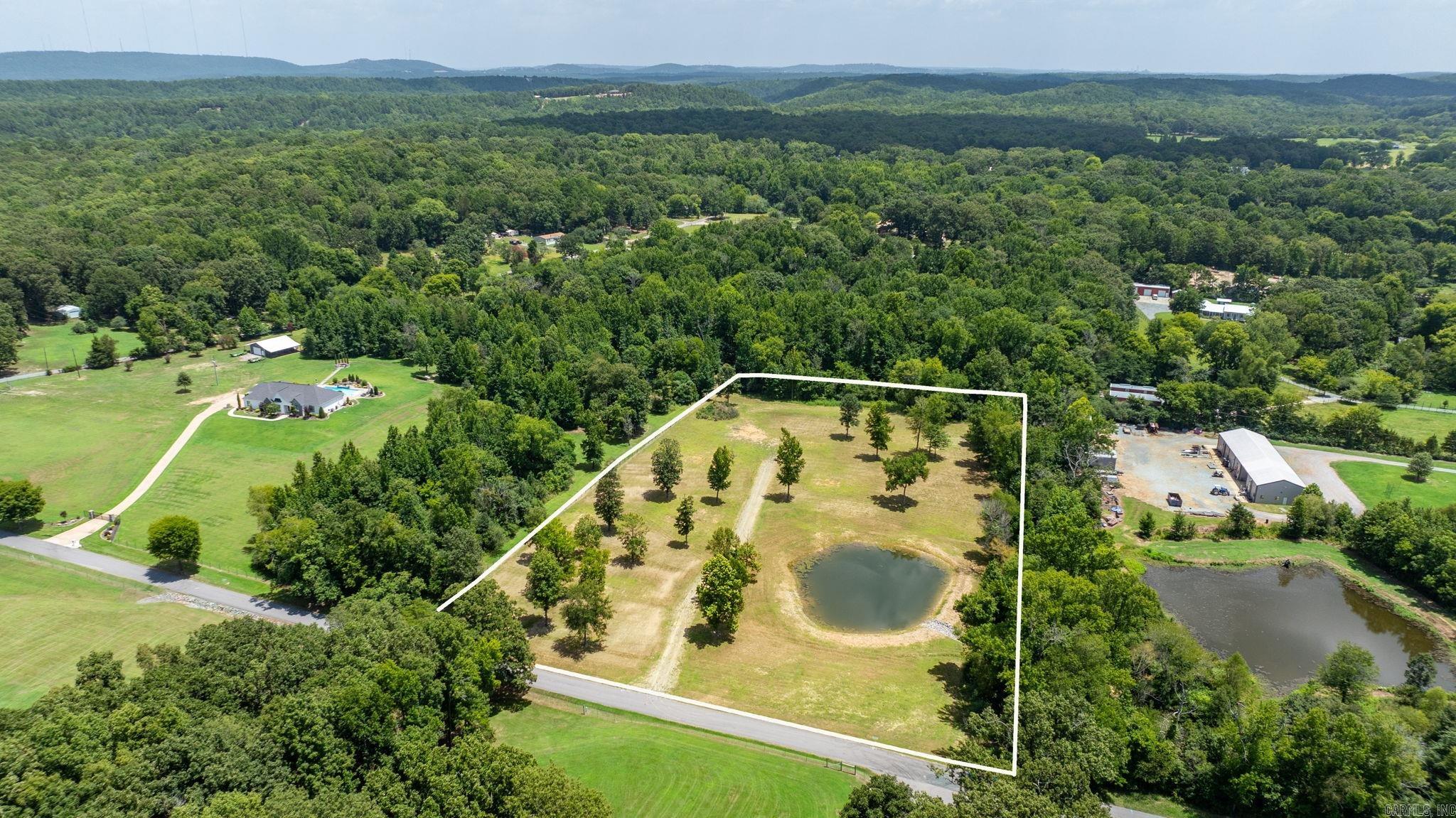 INCREDIBLE 5-acre property on a dead end comes with a survey and perc test already available, saving you time and giving you a head start on building. Located just 10 miles from I-430, you'll enjoy the perfect blend of peaceful country living and quick access to West Little Rock. The hard work has already been done with extensive dirt work completed, an established driveway in place, and a pond with proper drainage already created. Thoughtfully preserved trees throughout the property add natural beauty, character, and shade, while tree lines on three sides provide exceptional privacy and a secluded feel. If you've been searching for the perfect place to build your forever home, this one is ready to bring your vision to life. Drone video of the property is available.