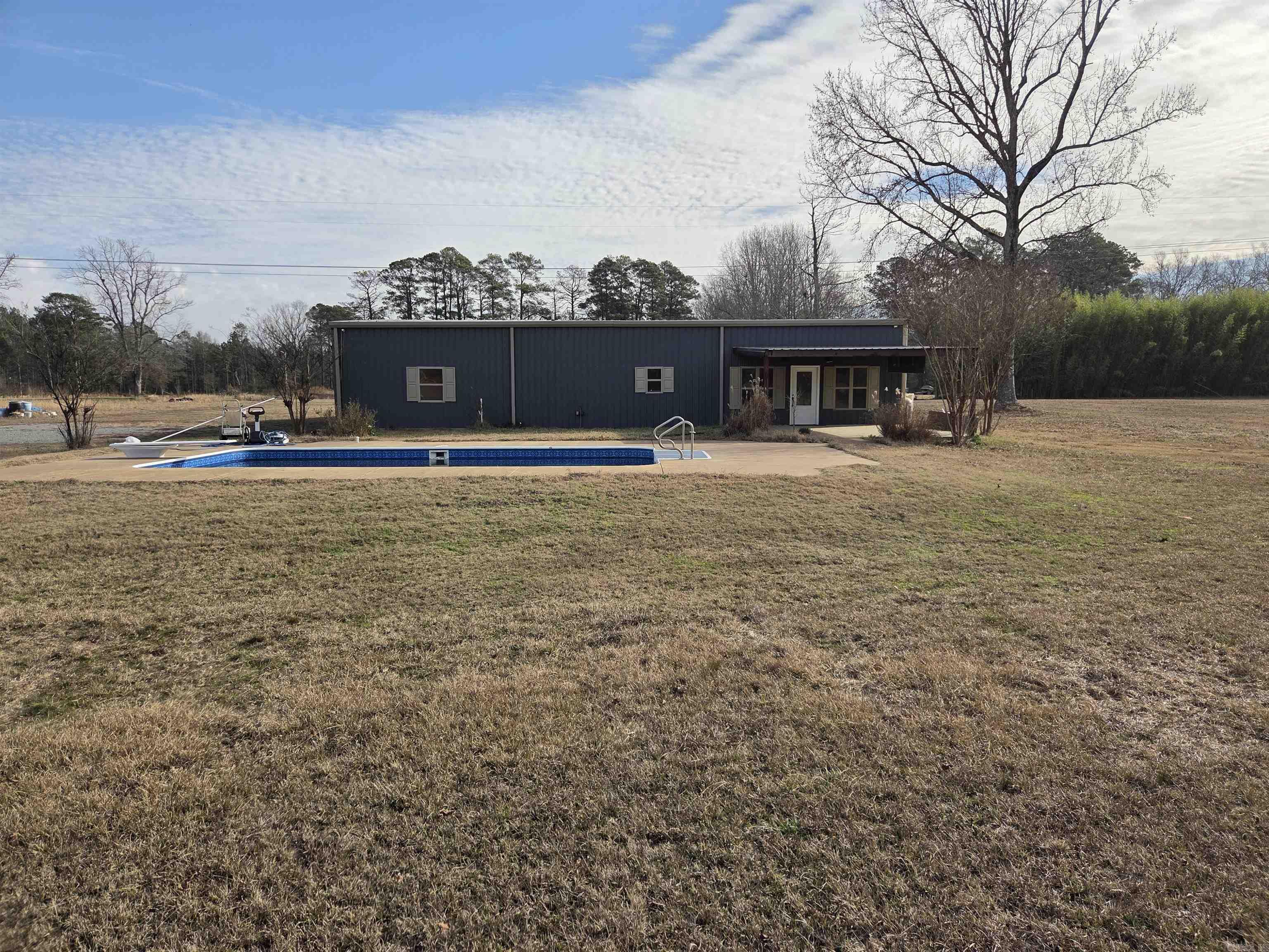 Tucked away at the end of a long, scenic drive, this 16.1-acre property offers privacy, space, and room to dream. The main home features two bedrooms with abundant additional space that can easily be converted into extra bedrooms, living areas, or creative workspaces to fit your vision.  Out front, enjoy a refreshing pool that sets the tone for relaxed country living, while the back of the property opens up to a peaceful pond—perfect for unwinding, wildlife watching, or creating your own backyard escape. Multiple buildings on the property add flexibility for storage, workshops, guest space, or future expansion.  Whether you’re looking to create a personal retreat, hobby farm, multi-use property, or simply a place with room to grow, this land offers a rare combination of natural beauty, privacy, and opportunity. A true hidden oasis with endless possibilities.