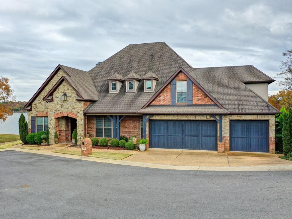 Beautiful home built by Carriage Custom Homes on the shores of Lake Hamilton. 4/3.5/3 2 Story features a barrel ceiling in foyer, vaulted and beamed ceiling in Great Room with a wall of windows overlooking the lake.  Hardwood floors, upgraded custom cabinetry. Huge private master suite with study/office and master bath. Guest bedrooms feature private baths. Huge bonus game room with snack bar , family area and bath. Decks are Tyvek easy care. Single Stall Covered Boat House with lift. Views are amazing!