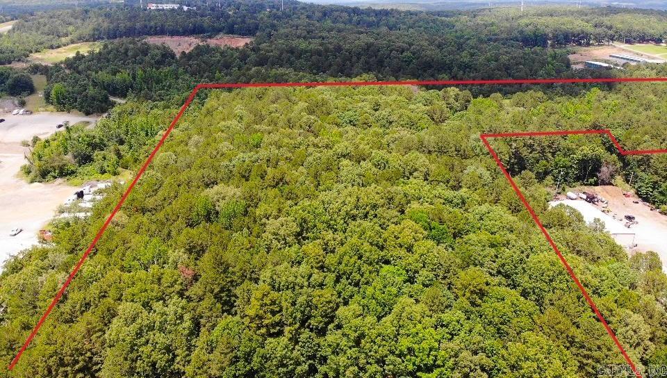 Prime commercial development opportunity in one of Heber Springs' fastest-growing corridors! This 22.64-acre property is divided into two sections, including a platted subdivision parcel and a larger main tract, providing flexibility for a wide range of commercial ventures. Ideally located along the Heber Springs Bypass, the property offers outstanding visibility, easy highway access, and an additional entrance from the adjoining residential road, making traffic flow convenient for customers and deliveries alike. The main tract features a relatively level landscape with a scenic pond, reducing development challenges while adding natural appeal. Surrounded by established, well-known local businesses and ongoing commercial growth, this location is perfectly positioned to benefit from the area's continued expansion. Whether you're planning retail, professional offices, restaurants, medical facilities, mixed-use development, or another investment project, this property offers the space, accessibility, and location to bring your vision to life. Don't miss this exceptional opportunity to invest in the future of Heber Springs. All boundary lines are approximate and not exact.