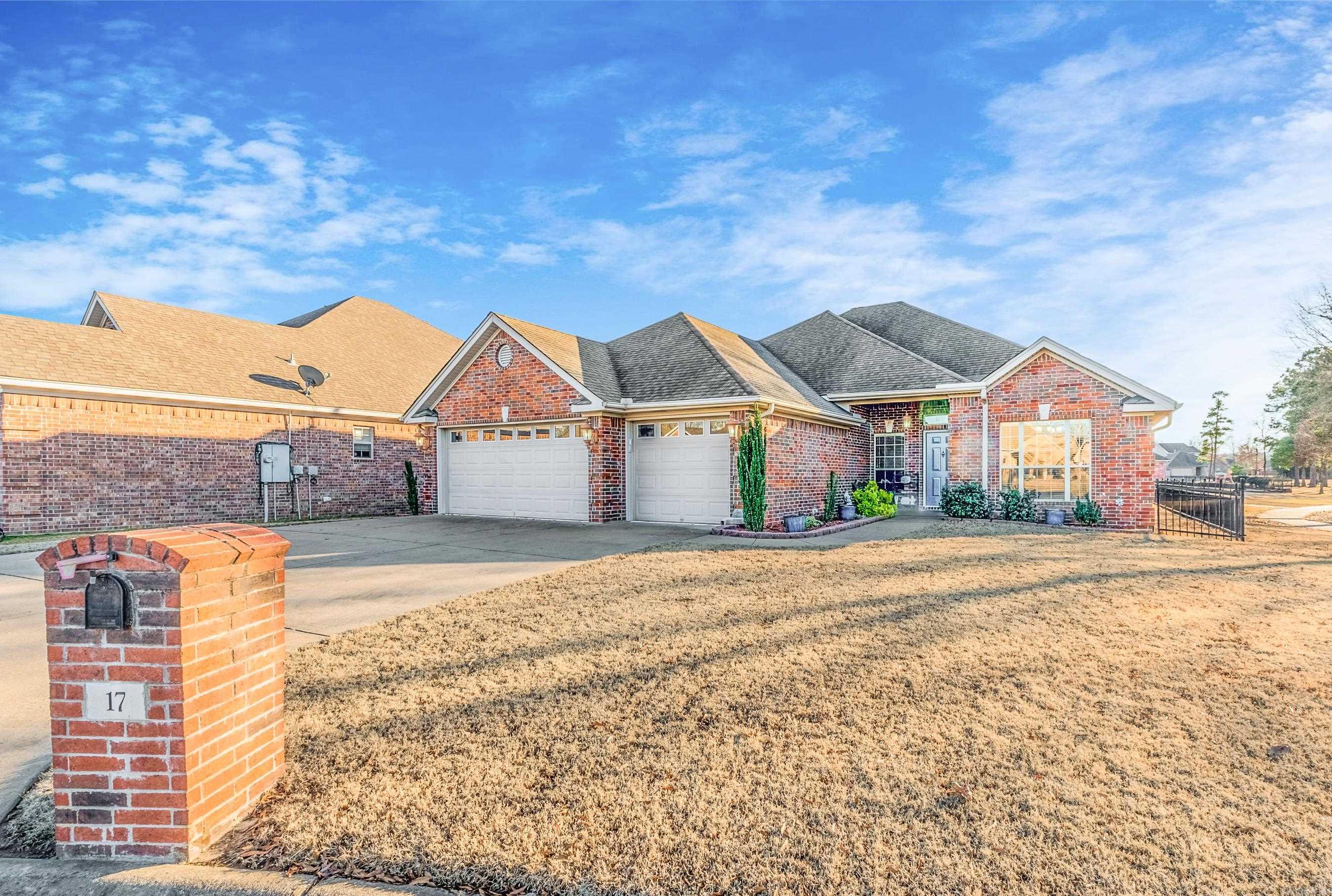 This beautifully maintained home is located at the end of a quiet cul de sac. The home offers an open floor plan with a gas log fireplace and vaulted ceilings.  The kitchen includes a gas stove, corian countertops, a pantry and the refrigerator conveys with the sale of the home.  Engineered hardwoods in dining room, one guest bedroom and the walkways of the home.  New LVT flooring in two guest bedrooms.  Primary bedroom has a tray ceiling and bay window perfect for a reading area.  The primary bath has double sinks, two walk in closets, jetted tub and a separate shower.   A 17' x 17' covered patio was recently added to enjoy  views out the back of the home.  Backyard is fully fenced with aluminum fencing. The home abuts a green space. Two west facing windows have remote controlled SunSetter Awnings. The three car garage includes a built in workbench with pegboard, insulated garage doors, painted floor and a partially floored attic.  The home has a brick exterior and gutters.