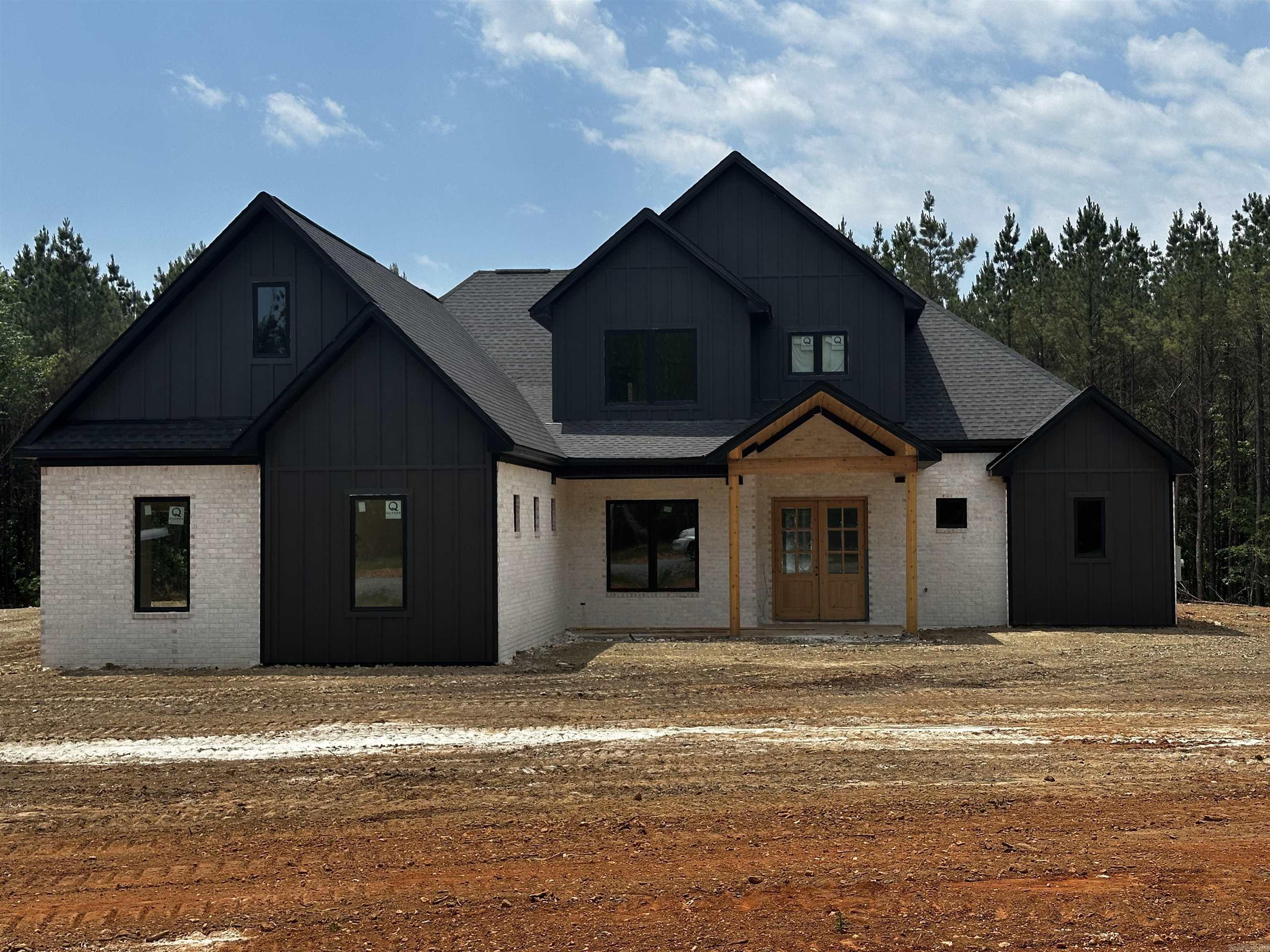 Set on over 8 acres, this stunning new construction home offers the perfect blend of luxury, privacy, and thoughtful design. With approximately 3,900 sqft, this home delivers exceptional space. Inside, you’ll find 5 bedrooms, 3.5 bathrooms, a dedicated office, with a large bonus room, including two en-suite bedrooms on first floor—perfect for guests or multigenerational living. The main living area features a cozy gas fireplace and opens seamlessly to the outdoor living space through a dramatic 12-foot sliding door, creating the perfect setting for entertaining.  The kitchen is designed for both function and style with a gas range, abundant storage, and a separate butler’s kitchen/pantry that makes hosting effortless.  The spacious primary suite is a space of its own, featuring a luxurious bath with a pass-through walk-in shower and freestanding soaking tub, custom storage, and thoughtful toe-kick lighting. With acreage, luxury finishes, and modern efficiency, this home offers a rare opportunity to enjoy space, comfort, and refined country living without sacrificing style or convenience. Minutes from the interstate and zoned for Benton Public Schools. Agents- See remarks