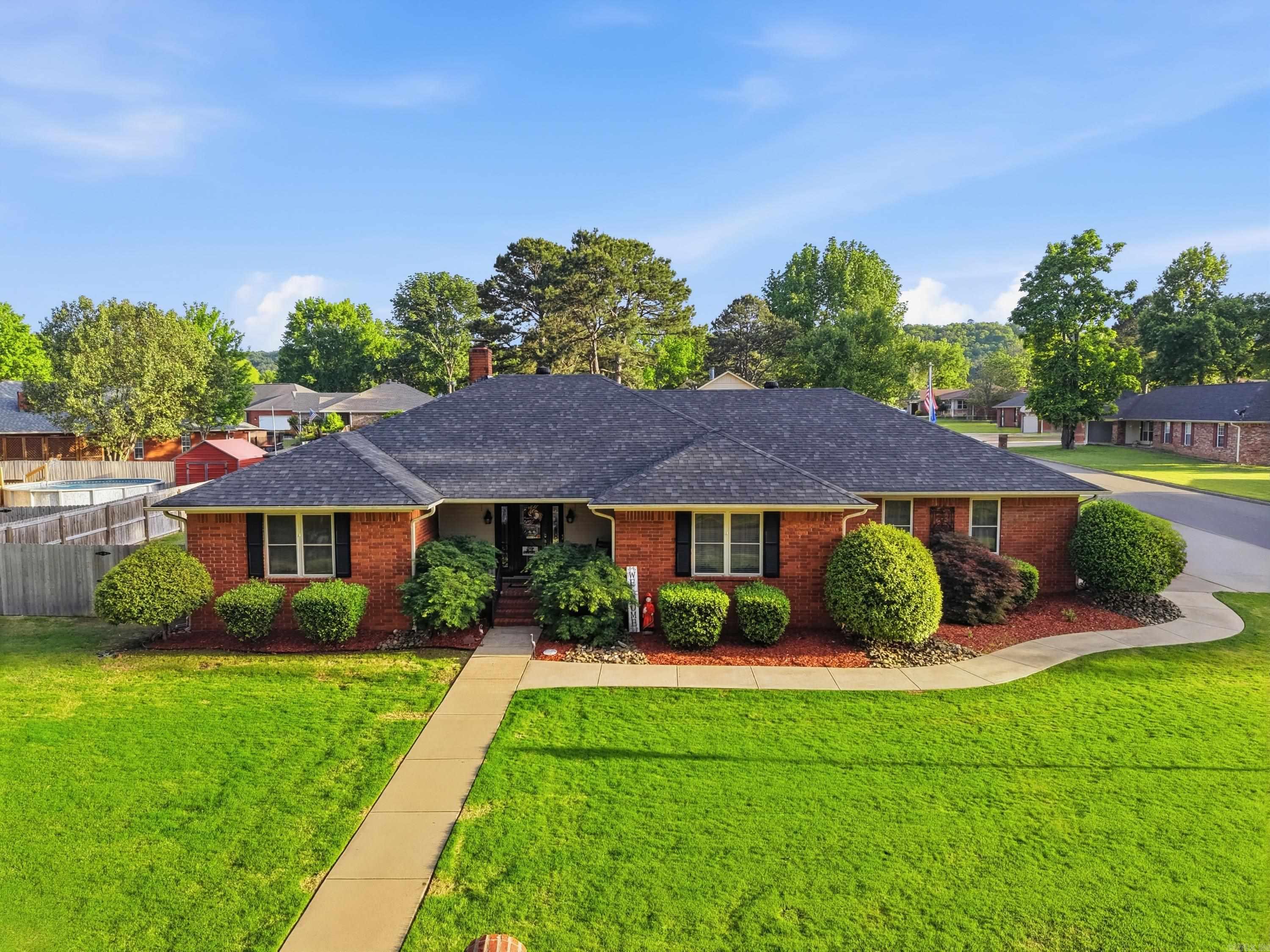 Located in one of Russellville’s popular neighborhoods near downtown, this well-maintained home sits on a large corner lot. The living room features a gas fireplace, while the oversized primary suite offers a soaking tub, walk-in shower, and heated floors. The kitchen includes stainless steel appliances, granite countertops, and a breakfast nook, with a formal dining room nearby. A spacious laundry room offers a half bath and extra storage. Enjoy the heated and cooled sunroom, covered patio, and fully fenced backyard with a rebuilt 12x16 shed. Additional features include a lawn sprinkler system, emergency generator, a roof replaced within the last 5 years, and a 50-gallon water heater upgrade.