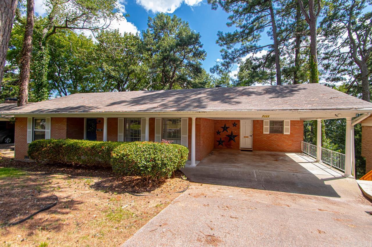 Versatile 4BR/3BA home with a 2-car carport and flexible split-to-the-rear design. The main level (1,271 SF) features a primary suite plus an additional bedroom and full bath, along with a spacious living area, dining space, and a well-appointed kitchen with granite countertops and stainless steel appliances. The lower level (568 SF) offers two more bedrooms, a full bath, large laundry room, kitchenette, and a cozy den with fireplace that opens to the back patio. Ideal for multi-generational living, Airbnb, or long-term rental, the lower level has both interior and exterior access and can be easily separated for privacy. Enjoy all hard-surface flooring throughout—tile, hardwood, and bamboo. Large storage/workshop space adds extra functionality. Furnishings and appliances can convey with an acceptable offer.