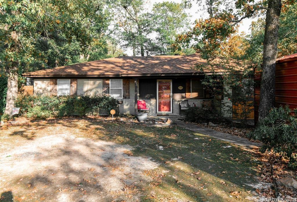 Check this out! Updated 4 bedroom brick home with an amazing man cave/bonus room off the back. Sitting on over 5 1/2 acres- newer wood look tile flooring, new fixtures, newer roof, huge dining area off the open kitchen, large remodeled hall full bath with walk in shower, and very convenient location with lots of trees for privacy! Newer wood fence and home was recently painted, a new 20x24 shop, 2 carports with storage, and another building being used as a salon. Rural development eligible!