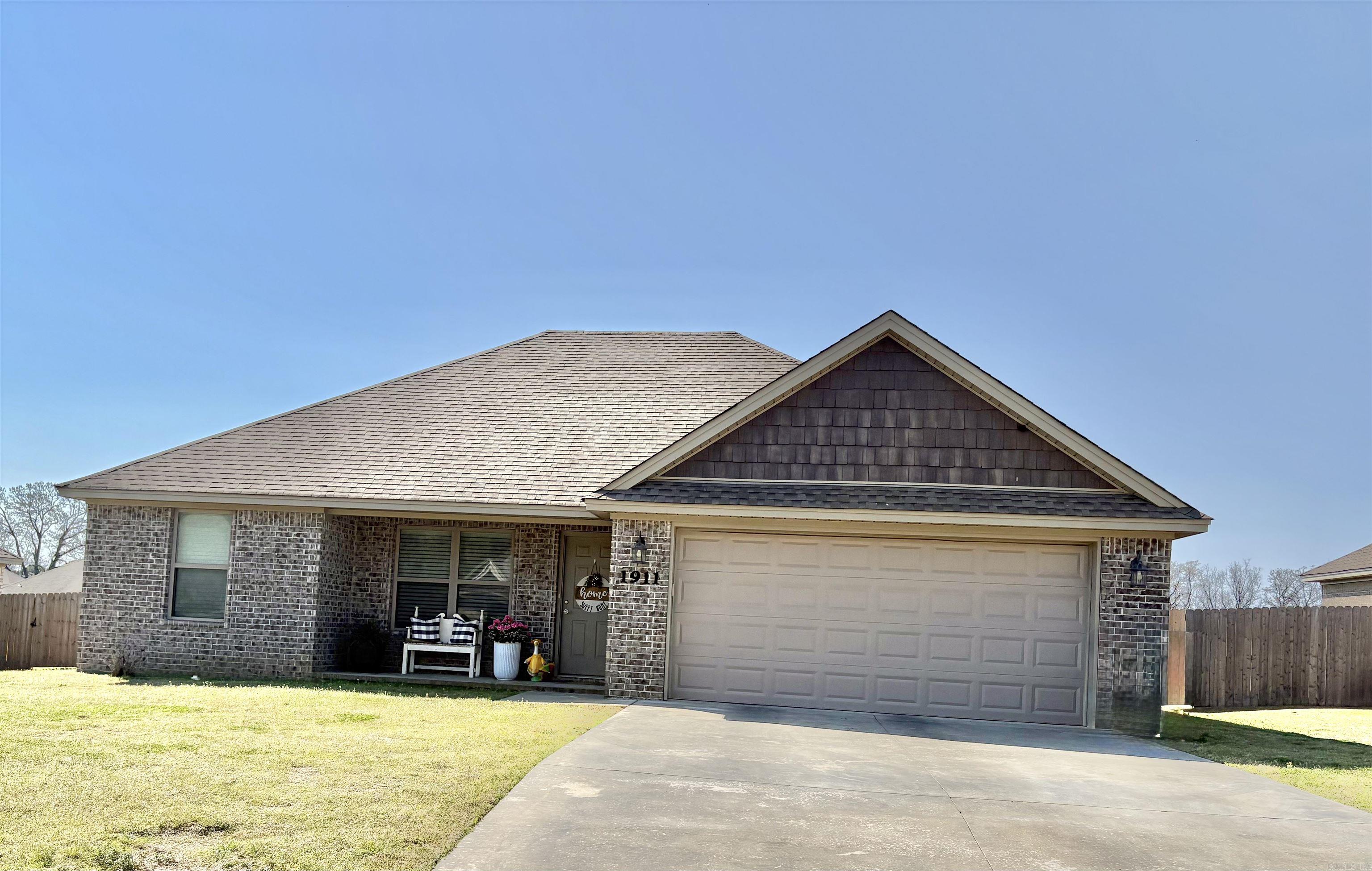 This doll house is better than new!  Has blinds throughout, privacy fenced yard w/double gate on one side & single gate on other side and is immaculate inside.  Open kitchen and living area.  Pantry.  Split floor plan.  Primary suite features spacious walk-in closet w/shelves for storage & has shower / tub combo.    Guest bath features walk-in shower.  Bdrms have carpet.  LVP flooring kin kitchen & living room.  Tile flooring in laundry & baths.  Nice sized laundry room is near primary suite.  Two car garage.  Some floored attic space.  Patio overlooks big back yard.