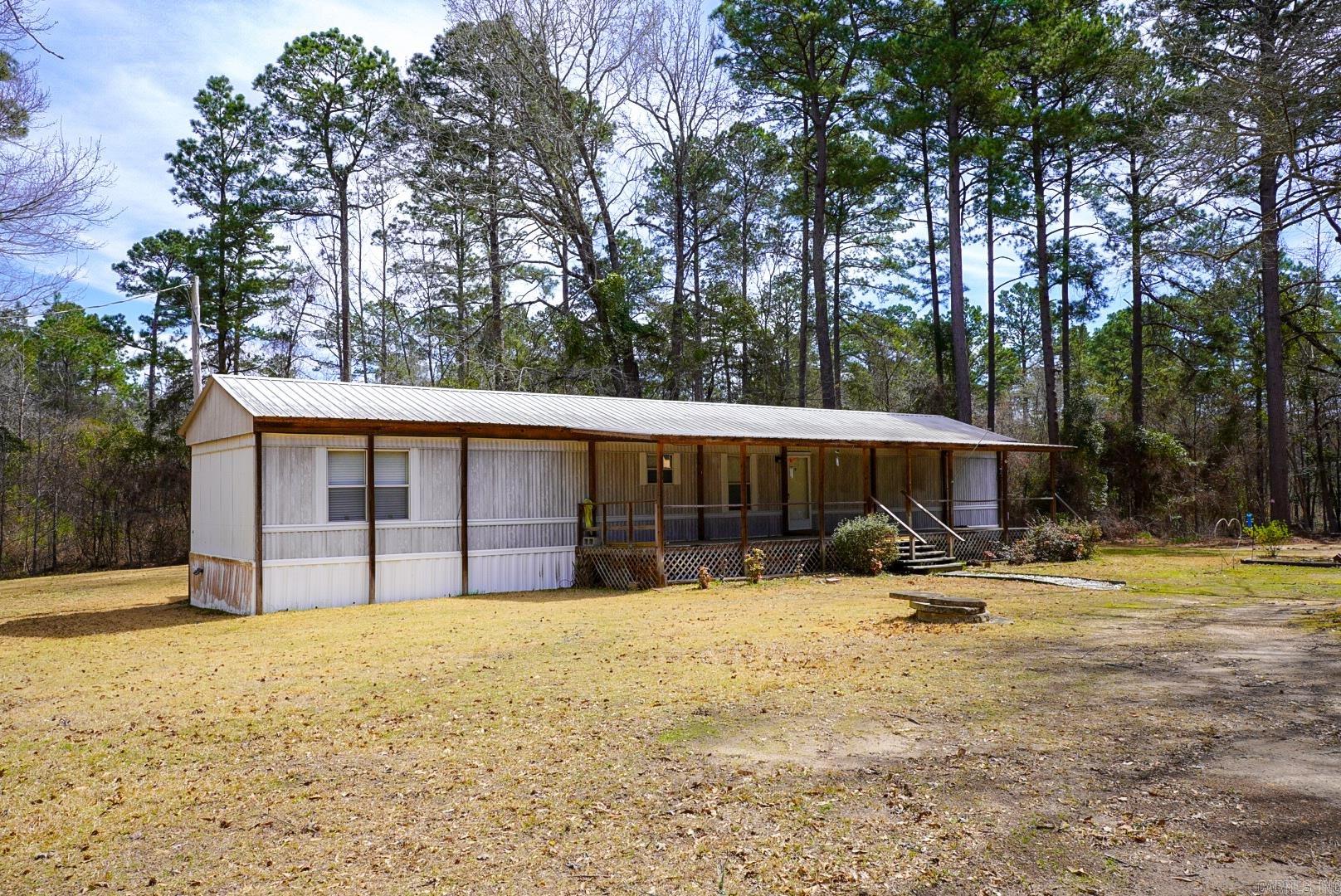 Escape to the quiet countryside with this 3-bedroom, 2-bathroom home nestled on just over 1.5 acres outside city limits. This well-maintained manufactured home offers a spacious open-concept living area, seamlessly connecting the kitchen, dining, and living room--perfect for gatherings or every day living.   Enjoy your morning coffee or unwind in the evening on the covered front and back porches, where you can take in the peaceful surroundings. Plus, stay comfortable year-round with a brand-new HVAC system! With plenty of space for gardening, outdoor activities, or even adding a workshop, this property offers the perfect blend of privacy and potential.   If you're looking for affordable country living with room to spread out, this is the home for you! Schedule a showing today!