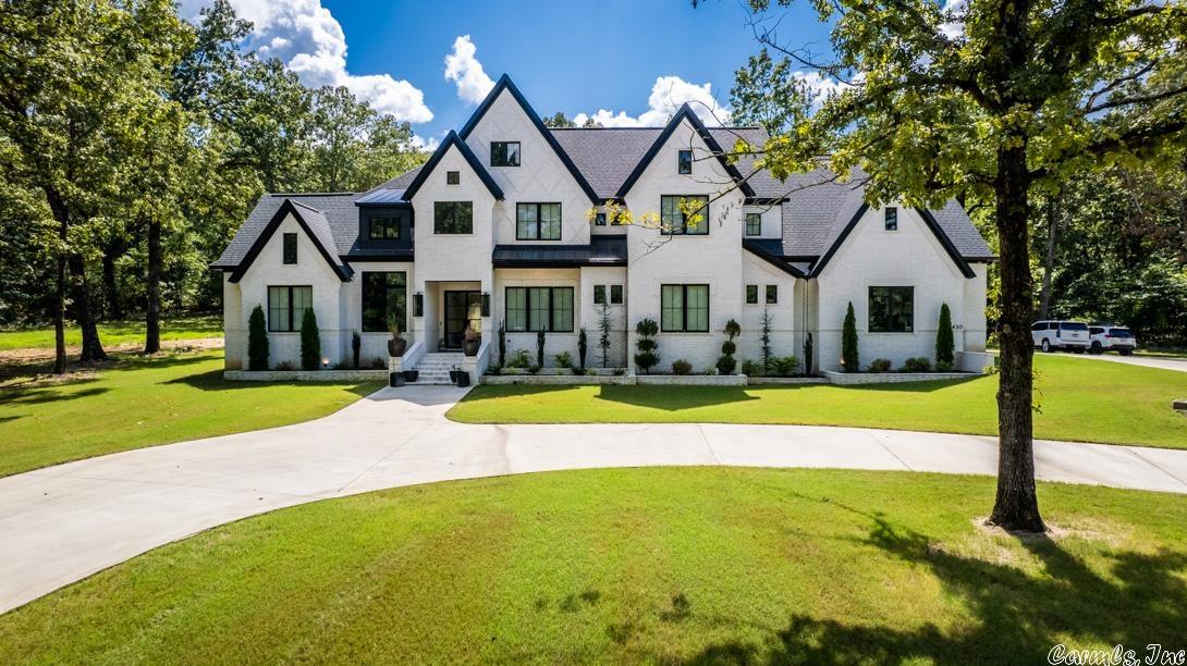 SHOW STOPPER! Custom built home sits behind dual gated entrance on almost 6 acres in NLR! This estate features stunning coved ceilings, tri-folding iron doors for easy indoor/outdoor flow, as well as stately finishes throughout!  The primary suite has personal laundry space, safe room, walk through shower, and so much more! The backyard is perfect for entertaining year round with the in-ground pool for Summer & built in heaters & woodburning fireplace for for cooler months! Truly a must see!