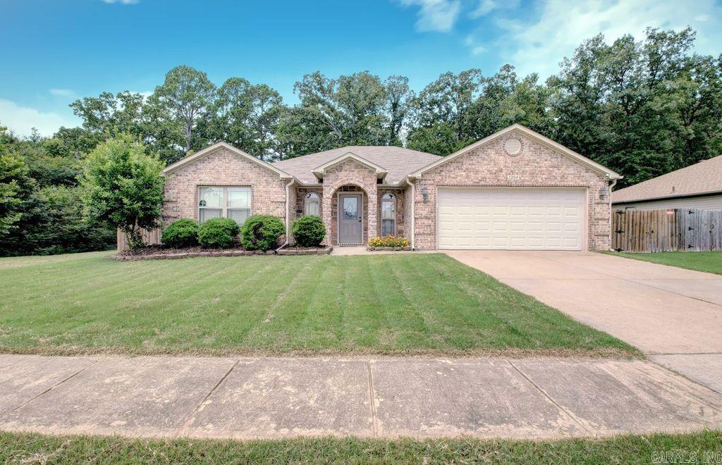 This beautiful, well-maintained four-bedroom home is move-in ready and offers the perfect combination of location, style, and functionality. From the moment you step inside, you'll be impressed by the custom foyer that sets the stage for the thoughtfully designed interior. The stunning, oversized kitchen, features granite countertops, central works island, ample cabinetry, flows into a dining room with plenty of room for gathering with family and friends. Wood flooring runs throughout the home, with tile in the wet areas for both beauty and durability. Step outside and discover your own private backyard retreat. Enjoy relaxing or entertaining year-round on the covered back deck overlooking the peaceful, private, fully fenced yard. Garden enthusiasts will love the dedicated gardening area, offering the perfect space to grow flowers, vegetables, or herbs. With its spacious layout, impressive updates, and exceptional outdoor living spaces, this home is ready for its next owners to move in and enjoy. Conveniently located in Bryant, close to schools, shopping, dining, and parks.