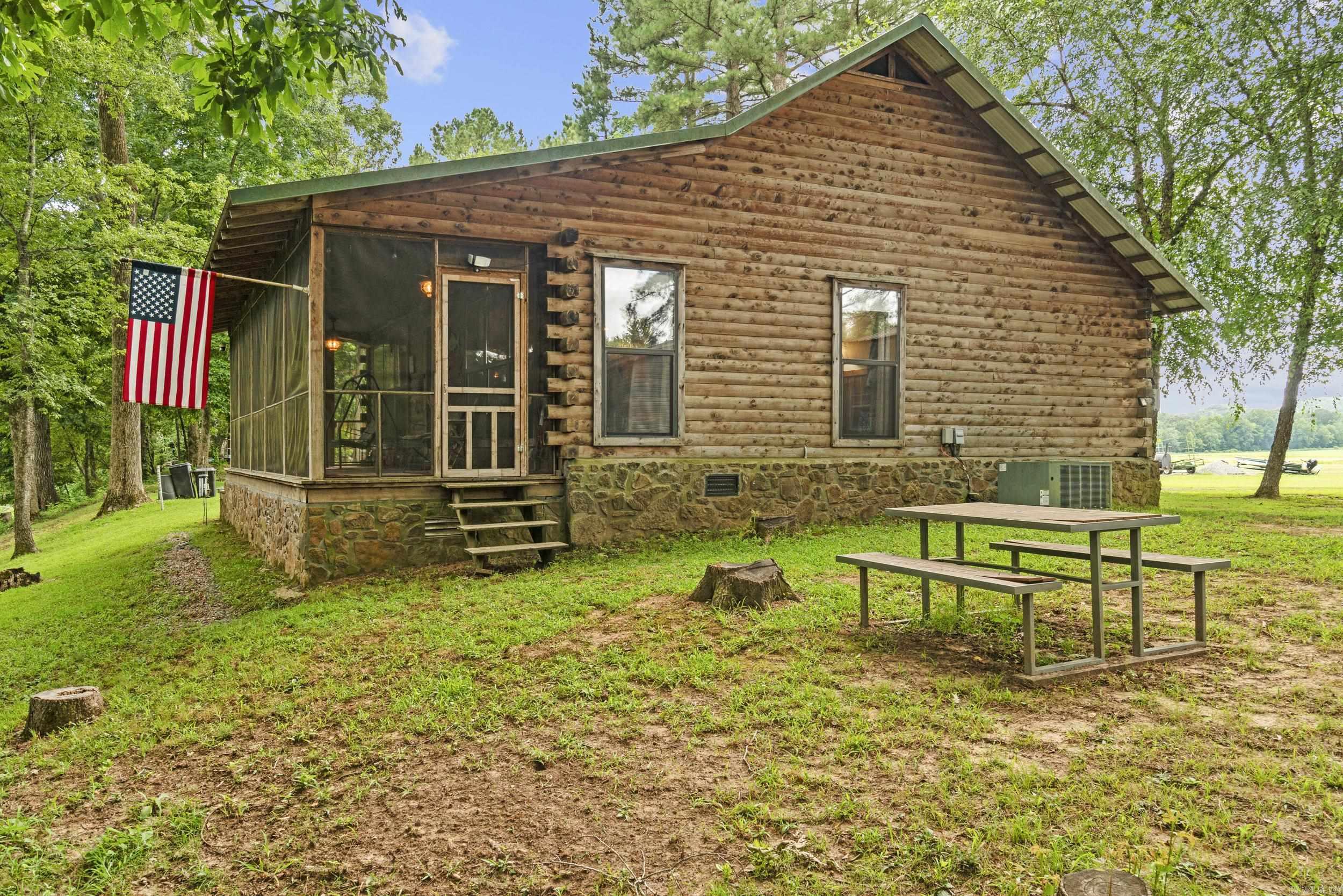 Welcome to your dream Little Red River getaway! Nestled on 2.73 acres along the pristine banks of the Little Red River, this charming 2-bedroom, 1-bathroom home with low-maintenance metal roof offers the perfect balance of comfort, privacy, and outdoor living.  Whether you're looking for a full-time residence, weekend retreat, or an income-producing short-term rental, this cozy log cabin is move-in ready and packed with rustic charm. The open living area features natural light and views of the river, while the updated kitchen and bath make everyday living convenient and enjoyable. The screened in porch allows you to enjoy those summer evenings with no bugs!  Step outside to enjoy a true nature lover’s paradise — your own private boat dock makes trout fishing, kayaking, and boating just steps away from your back door. With nearly 3 acres of gently sloping land, there’s room to expand, garden, or simply relax and enjoy the wildlife.  Located just minutes from downtown Pangburn and a short drive to Heber Springs or Searcy this riverfront gem offers tranquility without sacrificing convenience.