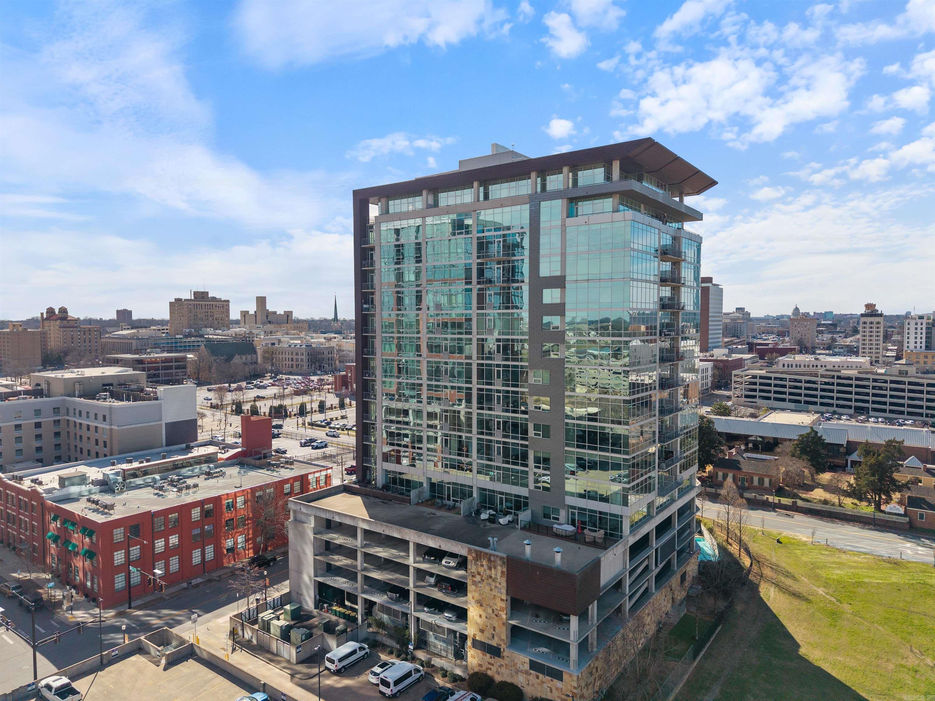 Experience sophisticated urban living in one of Capital City’s most prestigious high-rises. Designed by architect Tom Fennel, AIA, and built by Dave Grundfest Company, this exquisite residence offers elegance, craftsmanship, & convenience. Enjoy breathtaking panoramic views of the Arkansas River from the moment you enter. The interior features site-finished oak herringbone flooring, custom millwork, and meticulous detailing throughout. The main level boasts an expansive great room, formal dining, private study, and guest suite—all capturing stunning river & skyline views. The kitchen is a chef’s dream with top-tier appliances, custom cabinetry, and an informal dining area. A grand staircase or private elevator leads to the upper level, home to an opulent owner’s suite with a study, fireplace, spa inspired baths, and a custom walk-in closet. Two additional bedroom suites and a laundry room complete this level. Additional highlights include an incredible covered patio, an advanced AV system, and four parking spaces. Residents enjoy condo amenities: pool, spa, fitness center, dog-walking area, gated parking, concierge services, and direct access to Copper Grill with delivery service.